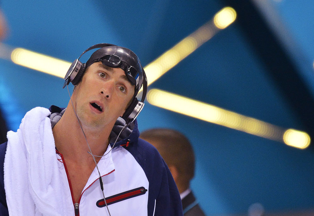 Michael Phelps of the U.S. listens to music as he arrives for the men’s 200m butterfly semi-finals at the London 2012 Olympic Games at the Aquatics Centre