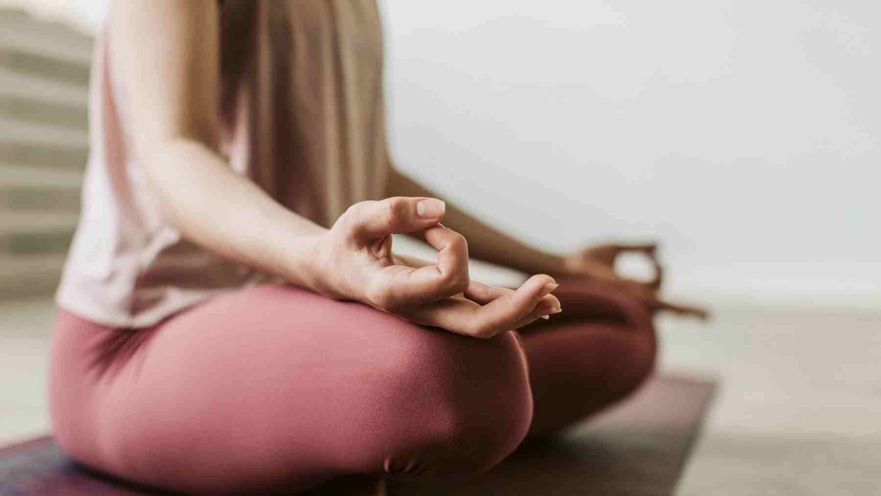 Person practicing mindfulness meditation to improve attention and reduce distractions