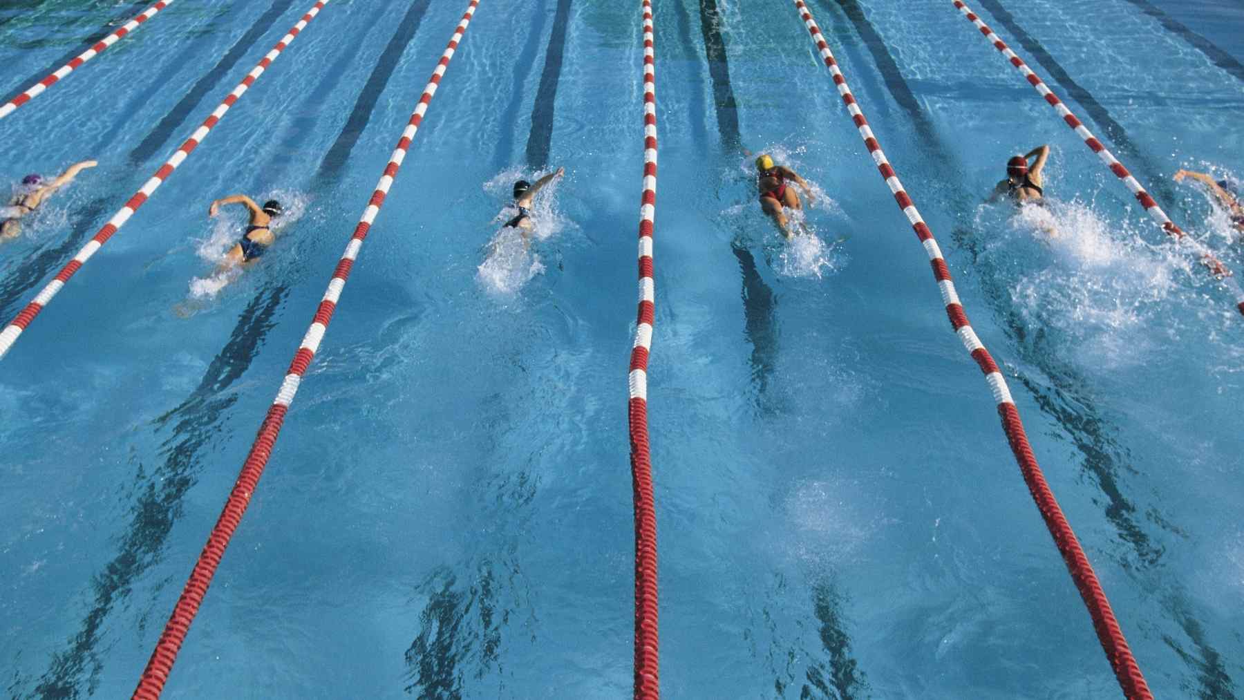Swimmers doing laps in a pool, a low-impact workout that can boost circulation and support heart health
