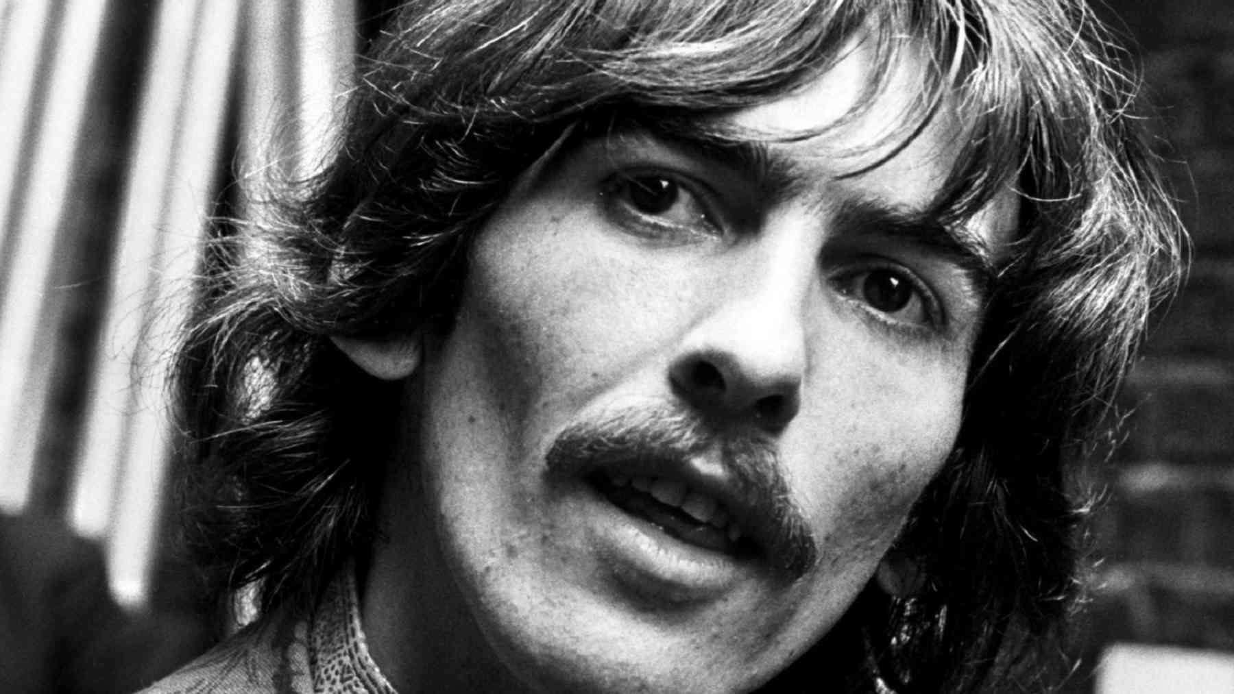 George Harrison in a black-and-white portrait linked to his famous quote about purpose, direction, and well-being