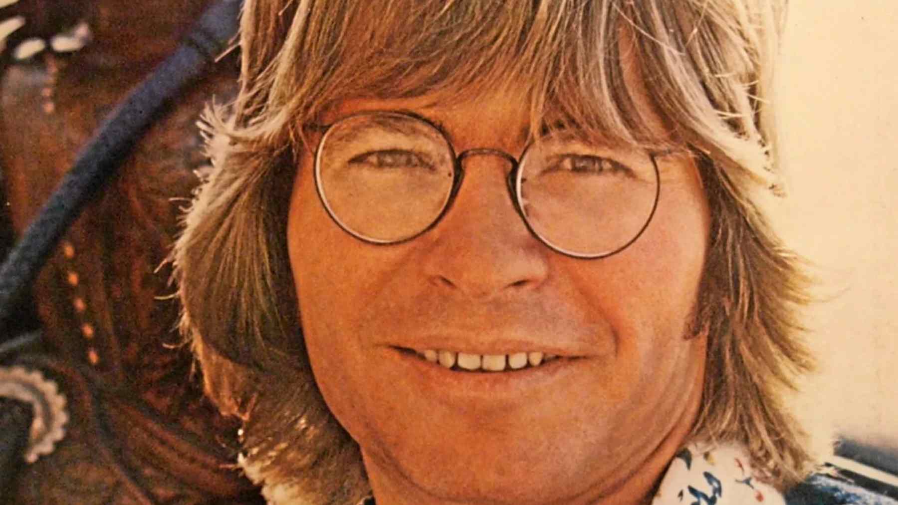John Denver smiling in a vintage portrait for an article about authenticity and mental health.