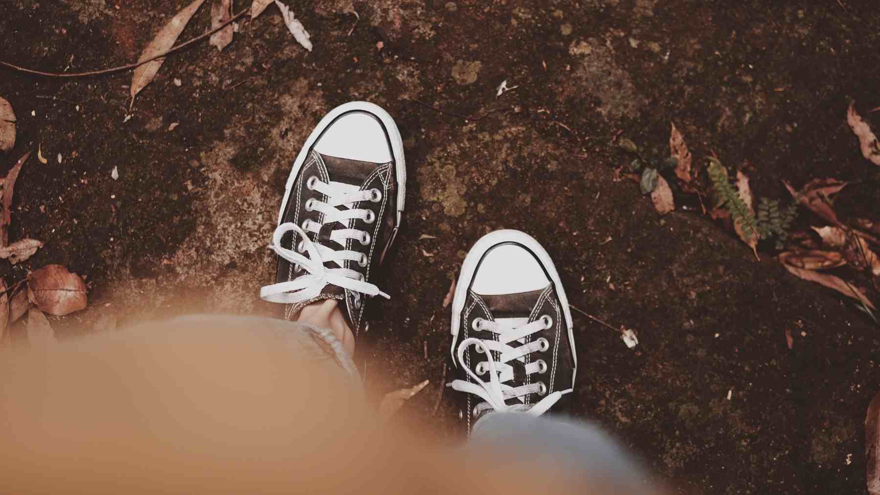 Person looking at the ground while walking, a body language habit psychology links to attention and balance