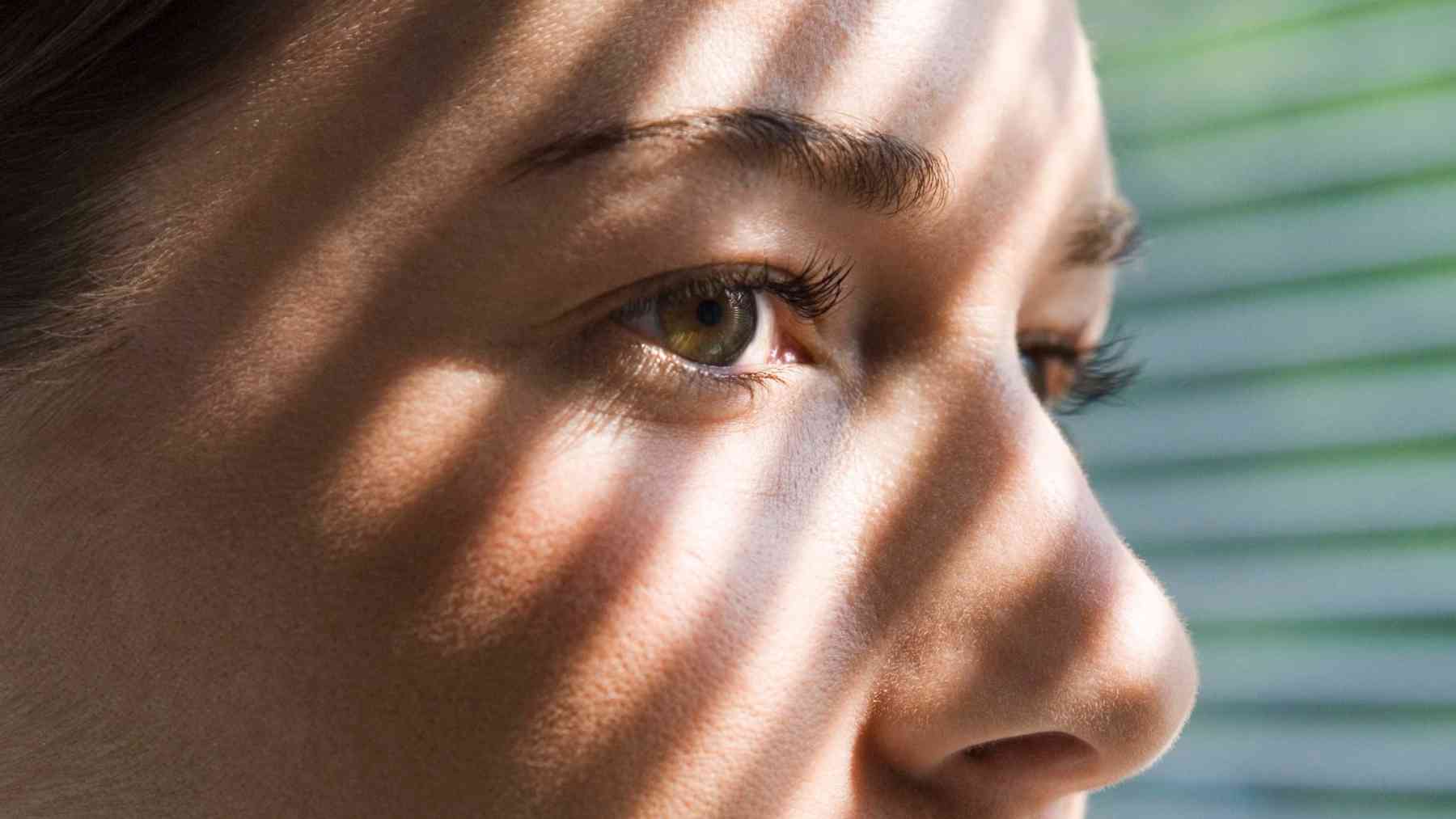 Close-up of a thoughtful woman reflecting on loneliness, emotional vulnerability, and social connection