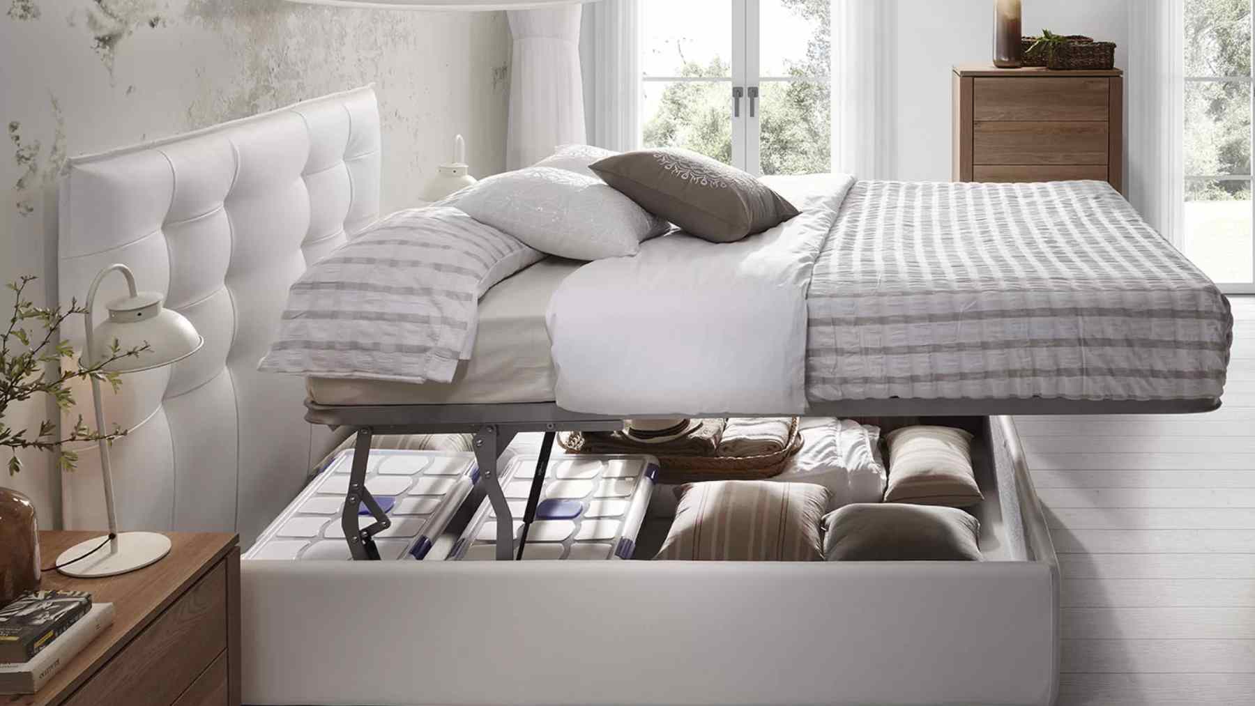 Lift-up storage bed with hidden under-bed compartments in a bright, calm bedroom
