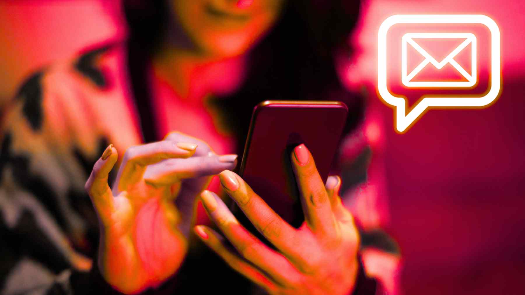 Woman holding a smartphone while receiving a message, illustrating a simple “thinking of you” text between friends.