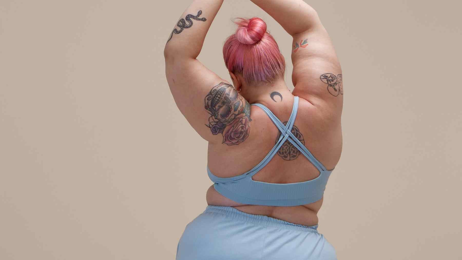 Person in blue activewear seen from behind, illustrating a story about visceral fat, belly fat, and metabolic health.