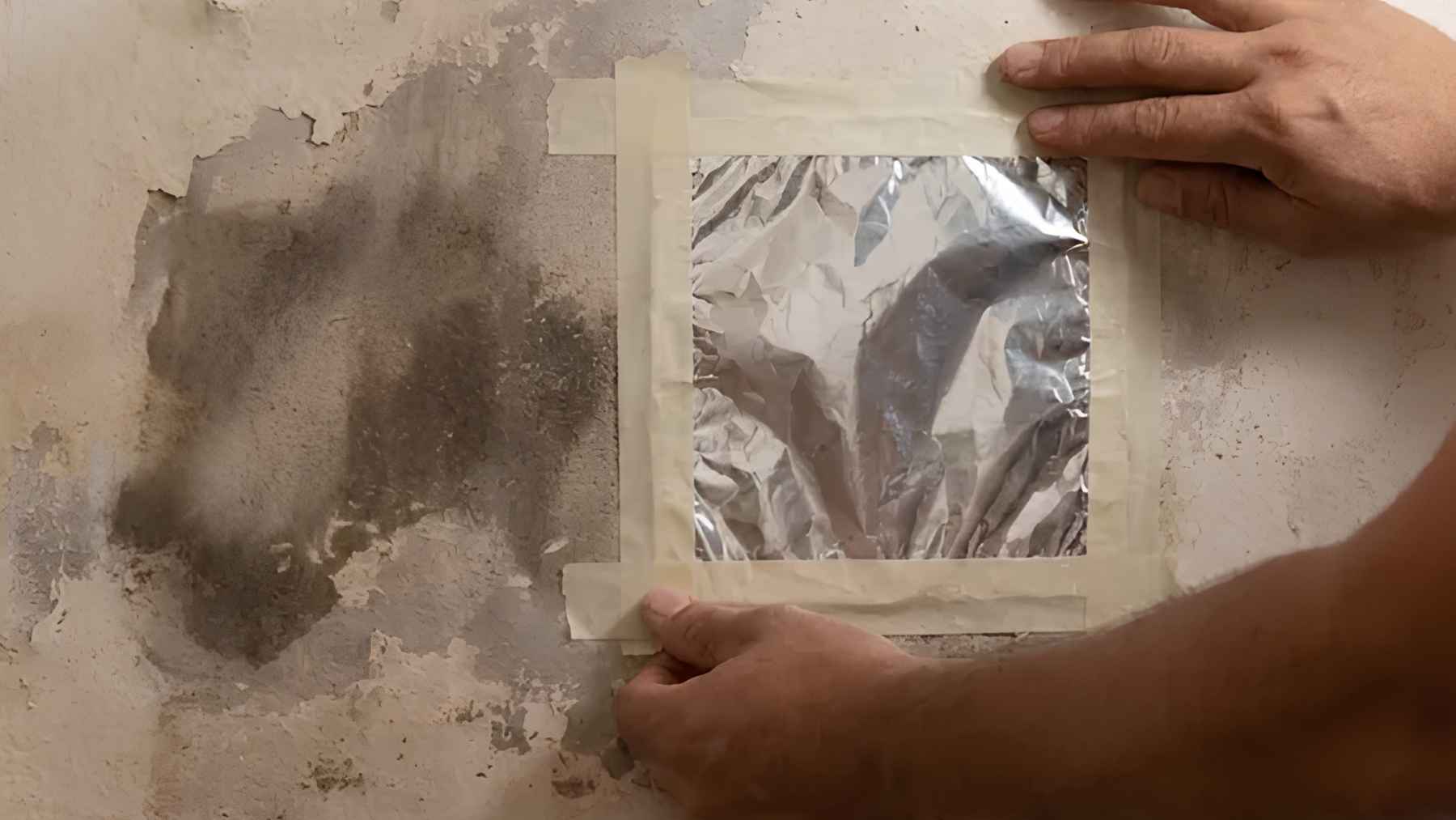 Aluminum foil taped to an interior wall during a home moisture test used to detect condensation or hidden water intrusion