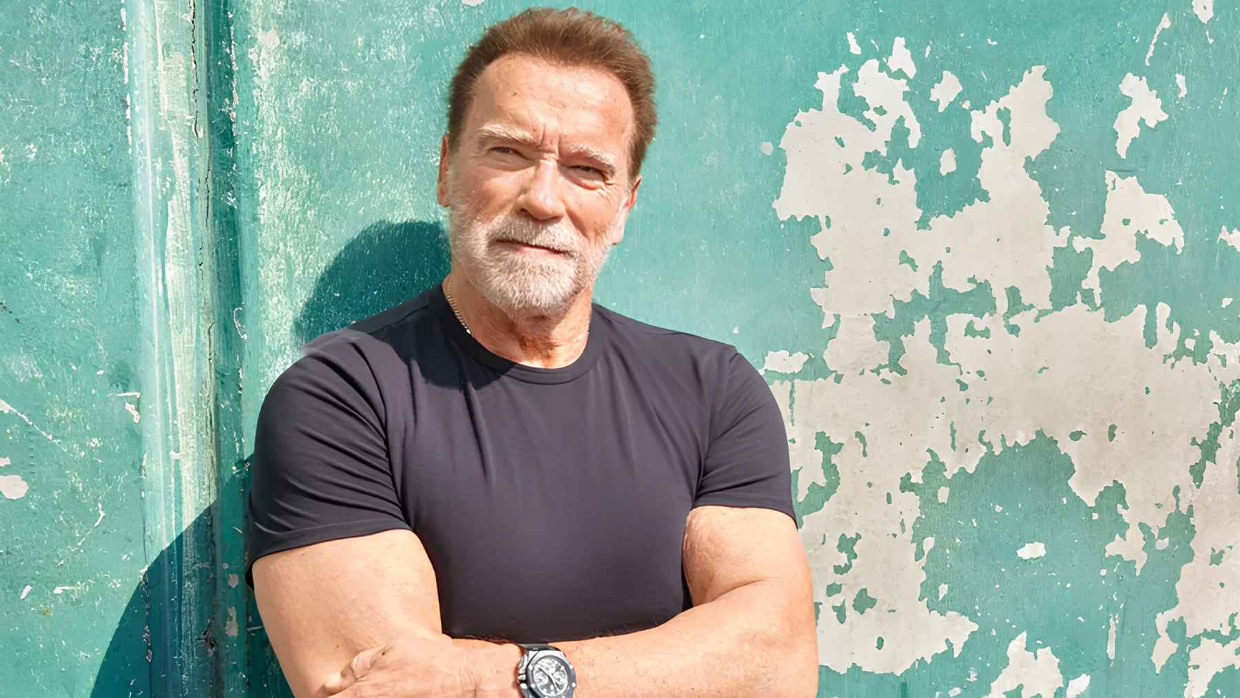 Arnold Schwarzenegger exercising at the gym in his late seventies, highlighting lifelong fitness, strength training, and healthy aging.