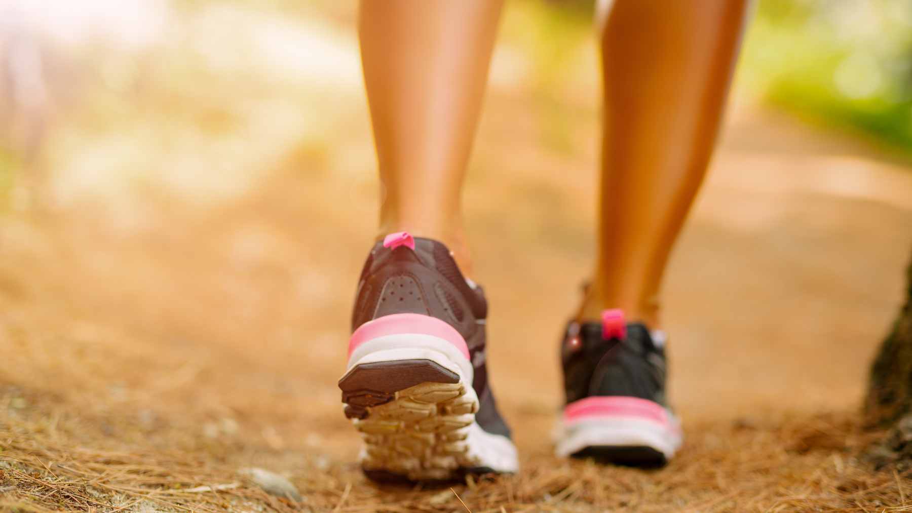 A person briskly walking in a park, representing simple aerobic exercise that helps maintain healthy blood pressure levels throughout the day.