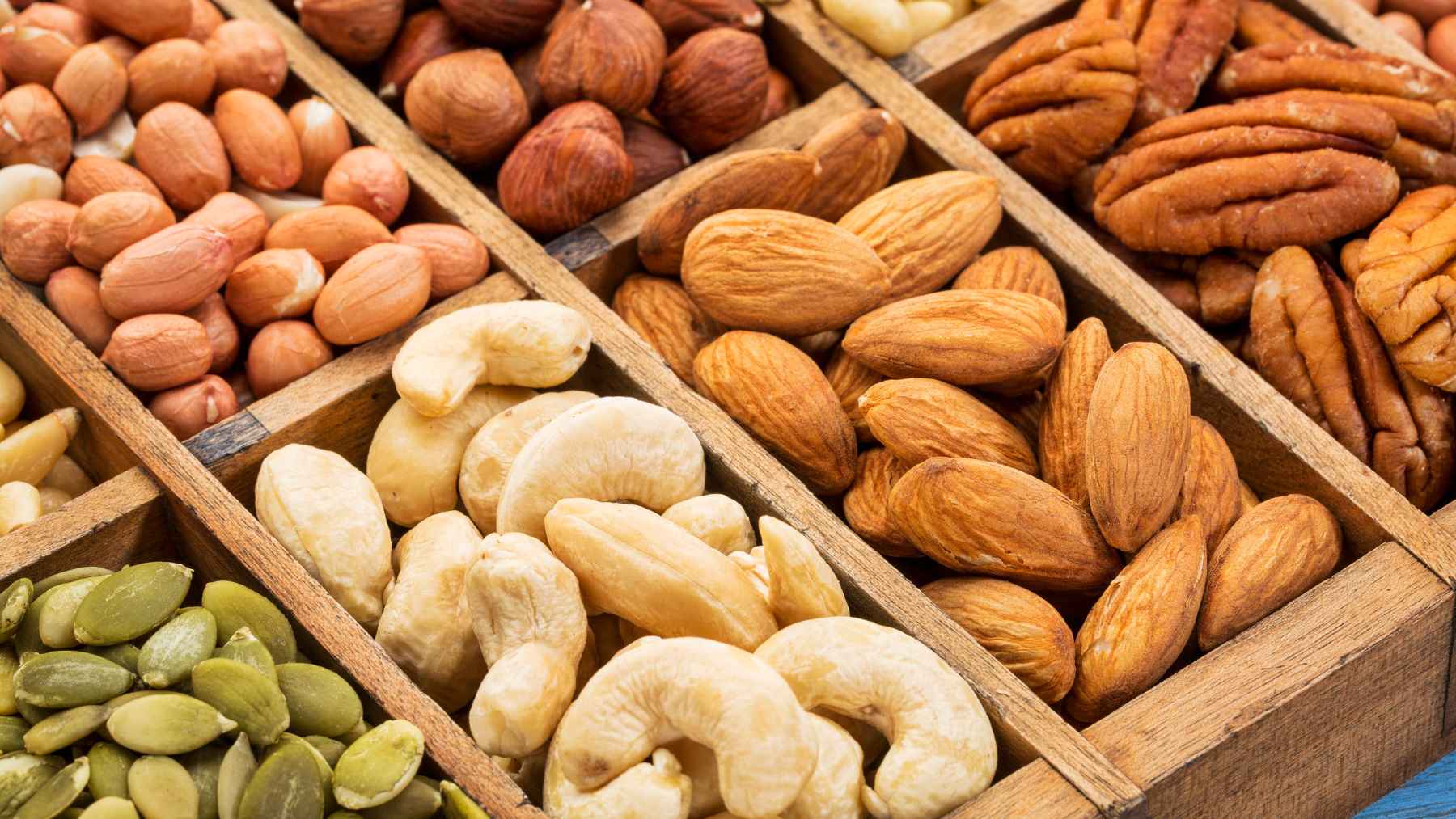 Assortment of walnuts, pecans, almonds, pistachios, and Brazil nuts displayed as nutrient-rich foods for heart and brain health