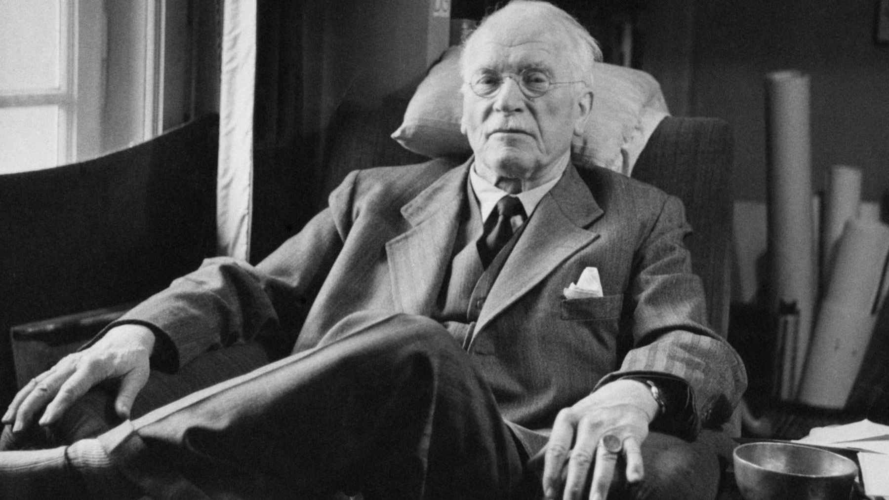 Carl Jung seated in his study, the Swiss psychiatrist whose ideas on loneliness, communication, and the human psyche continue to influence psychology