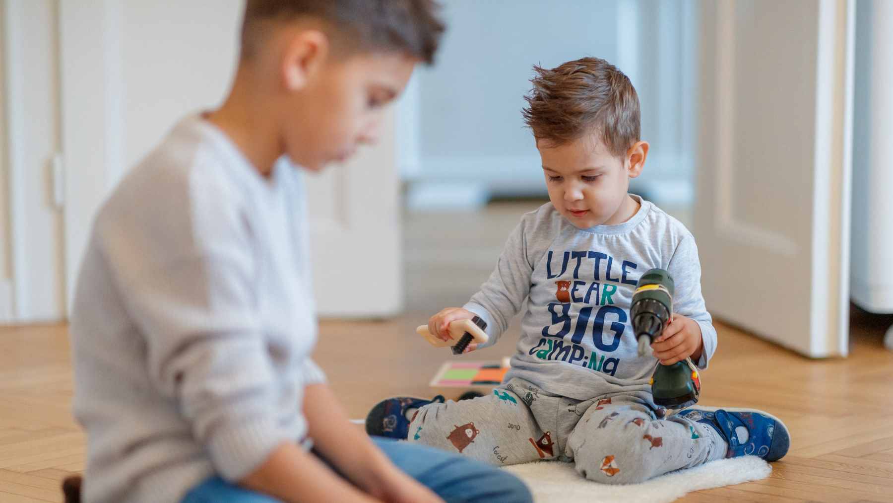Psychology suggests kids who helped care for younger siblings may have developed a kind of empathy that still shapes them years later 1 A young child gently comforting their younger sibling, demonstrating early childhood caregiving and emotional connection.