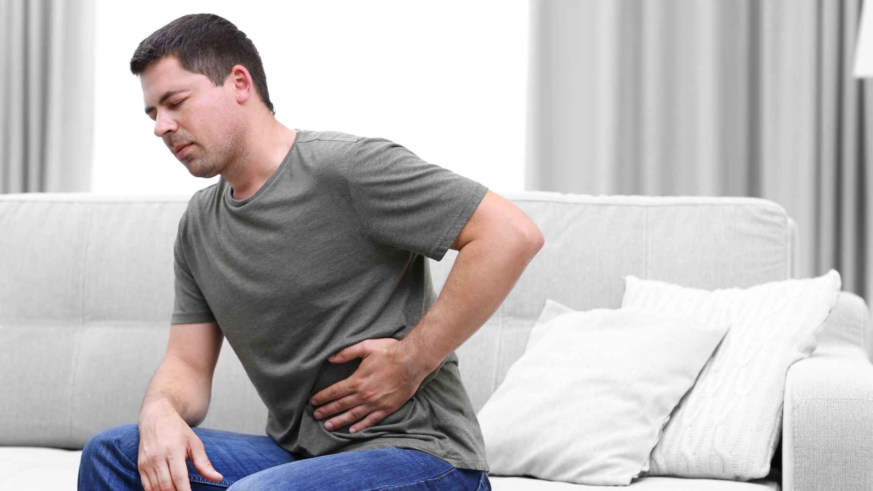 Medical professional reviewing patient records related to colon cancer symptoms, anemia, and early detection findings.