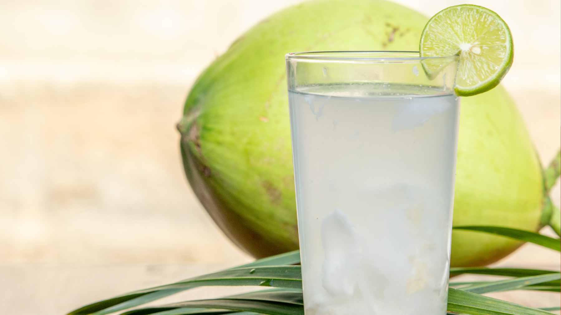 A cold, refreshing drink made with coconut water, citrus, and magnesium powder served in a glass to represent the "cortisol cocktail" trend.
