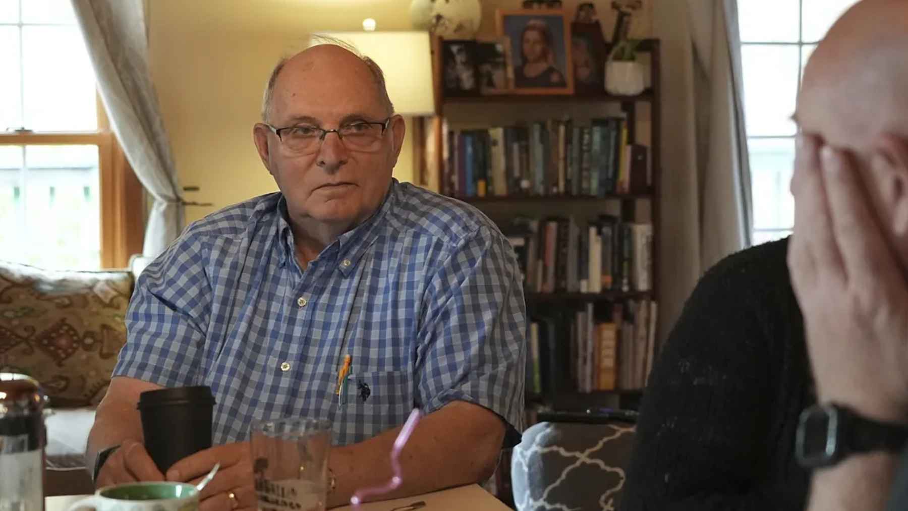 Doug Whitney, a carrier of a rare PSEN2 Alzheimer's mutation, speaking with family members as researchers study his unusual resistance to symptoms.