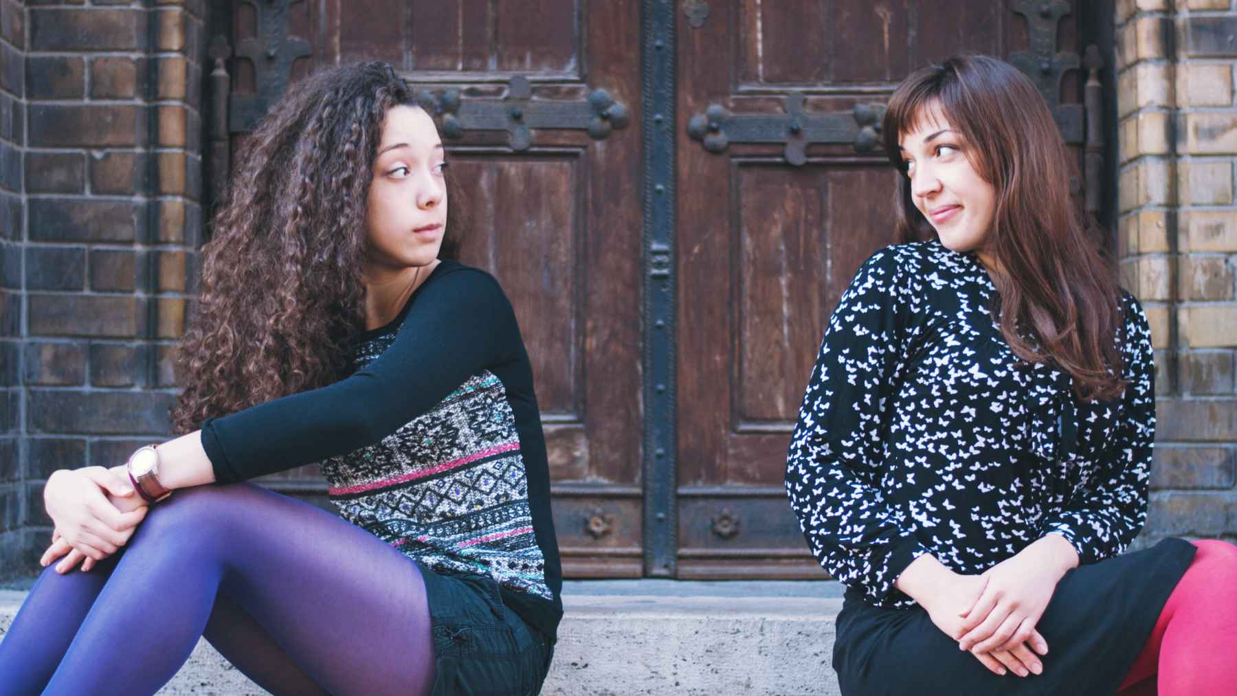 Two people engaged in a social interaction with different eye contact patterns, illustrating research on communication and body language