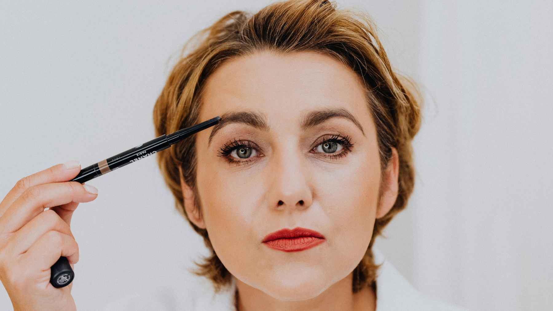 Person making eye contact with a subtle eyebrow raise, illustrating nonverbal communication and social cues.
