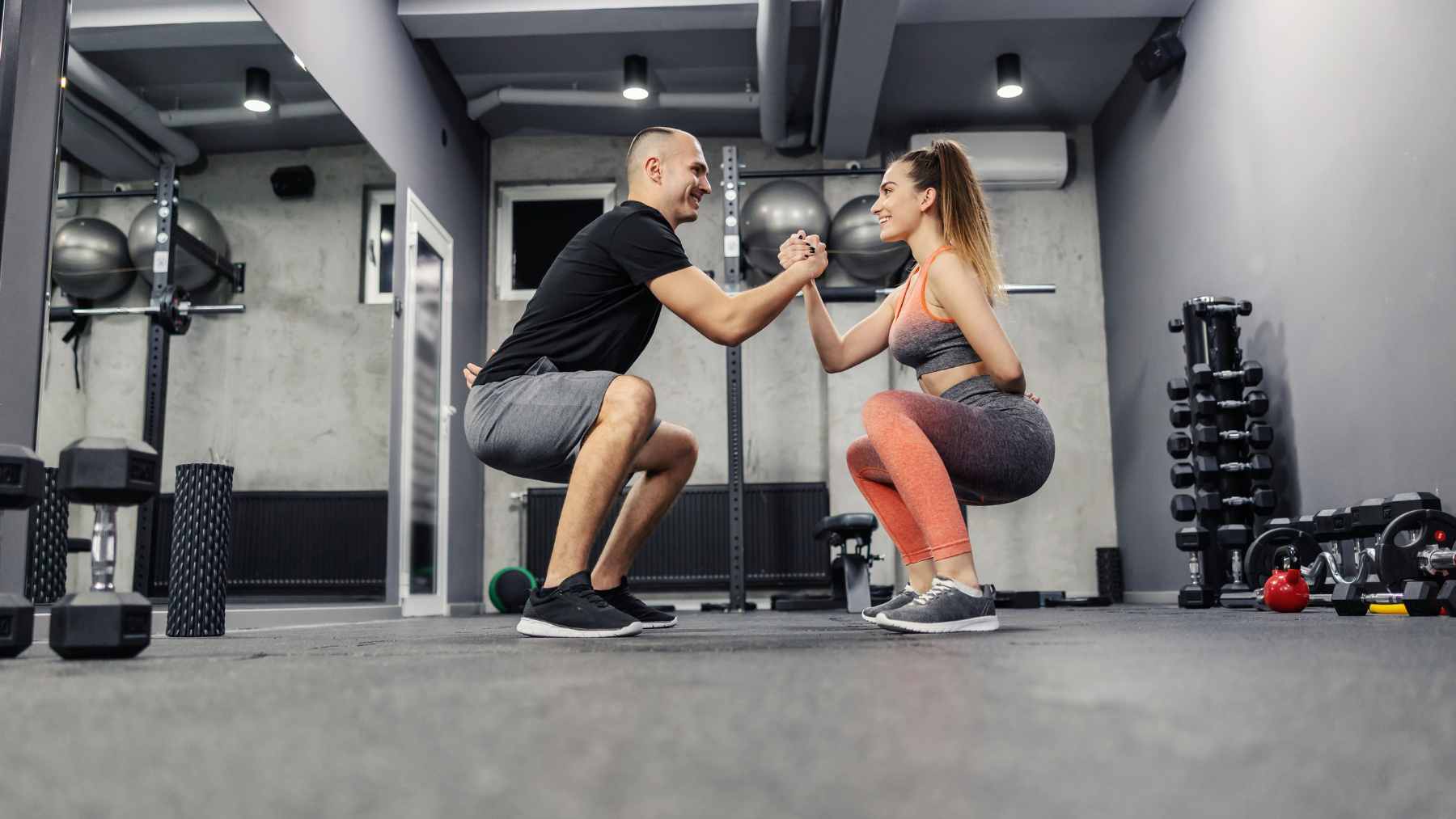A couple at home preparing for different exercise routines, representing a healthy acceptance of individual fitness preferences.