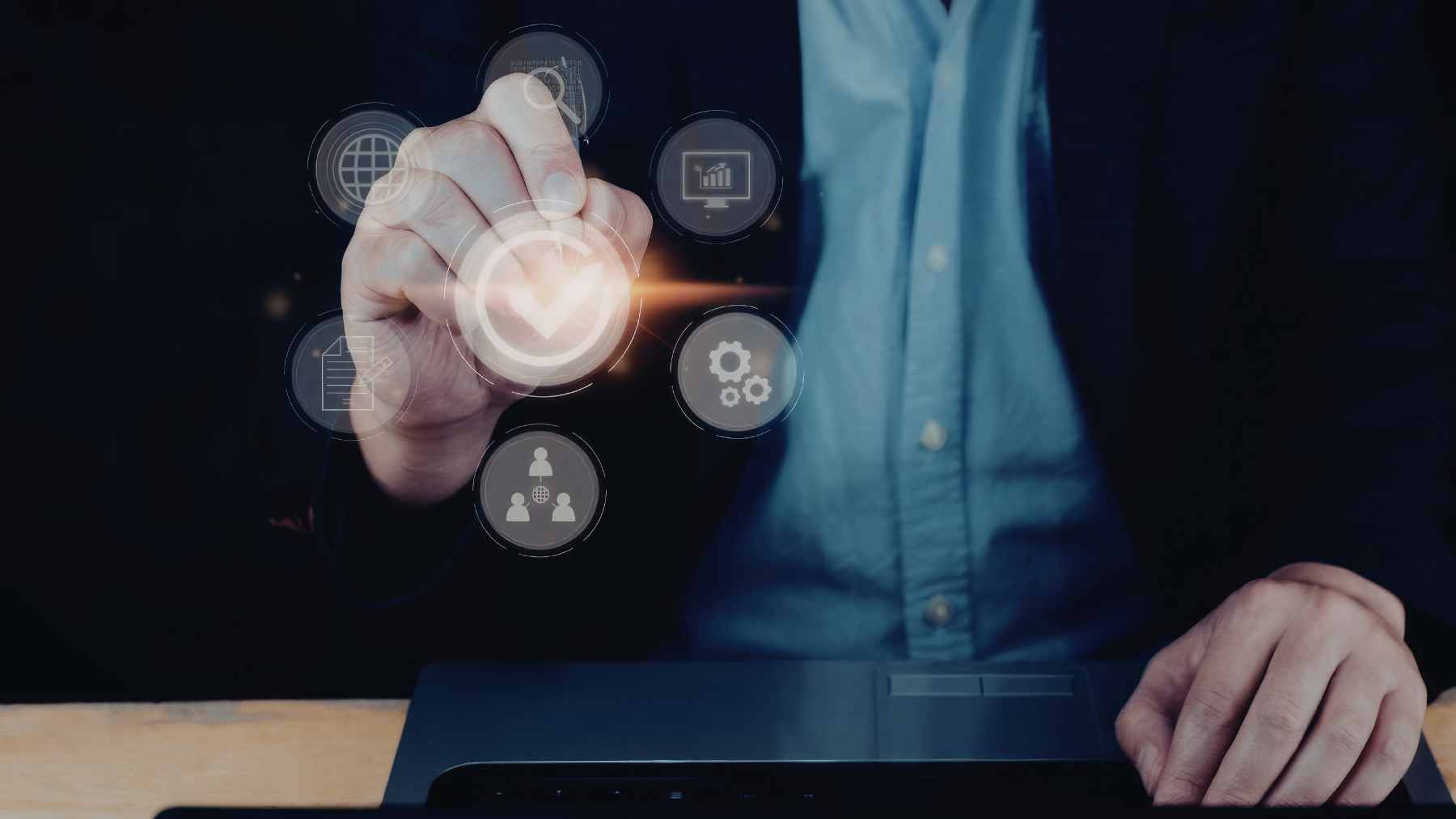 A young professional navigating multiple digital interfaces on a laptop, symbolizing the ability to adapt to fast-paced workplace technology.