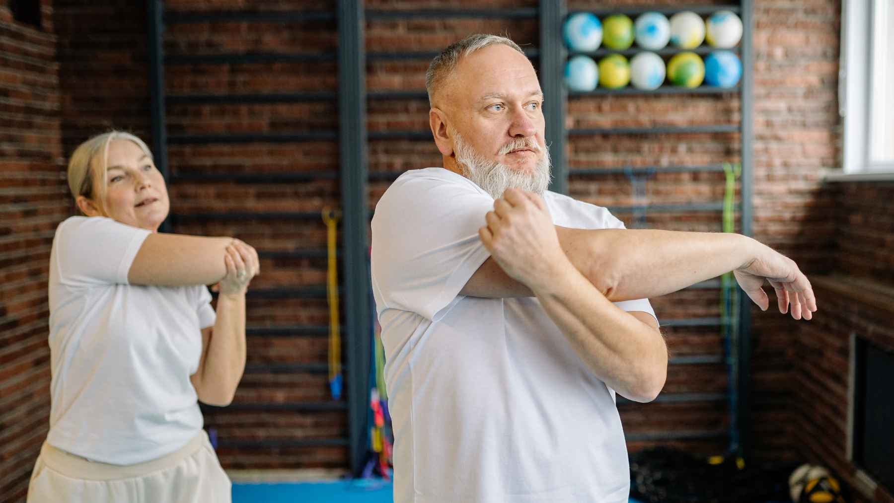 Middle-aged adult performing strength and balance exercises designed to maintain mobility, independence, and healthy aging.