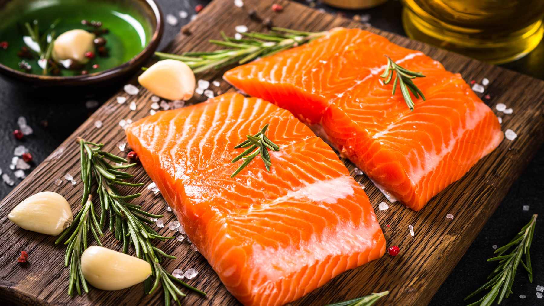 A selection of oily fish including herring, sprat, and salmon displayed on a market counter to promote heart-healthy eating habits.