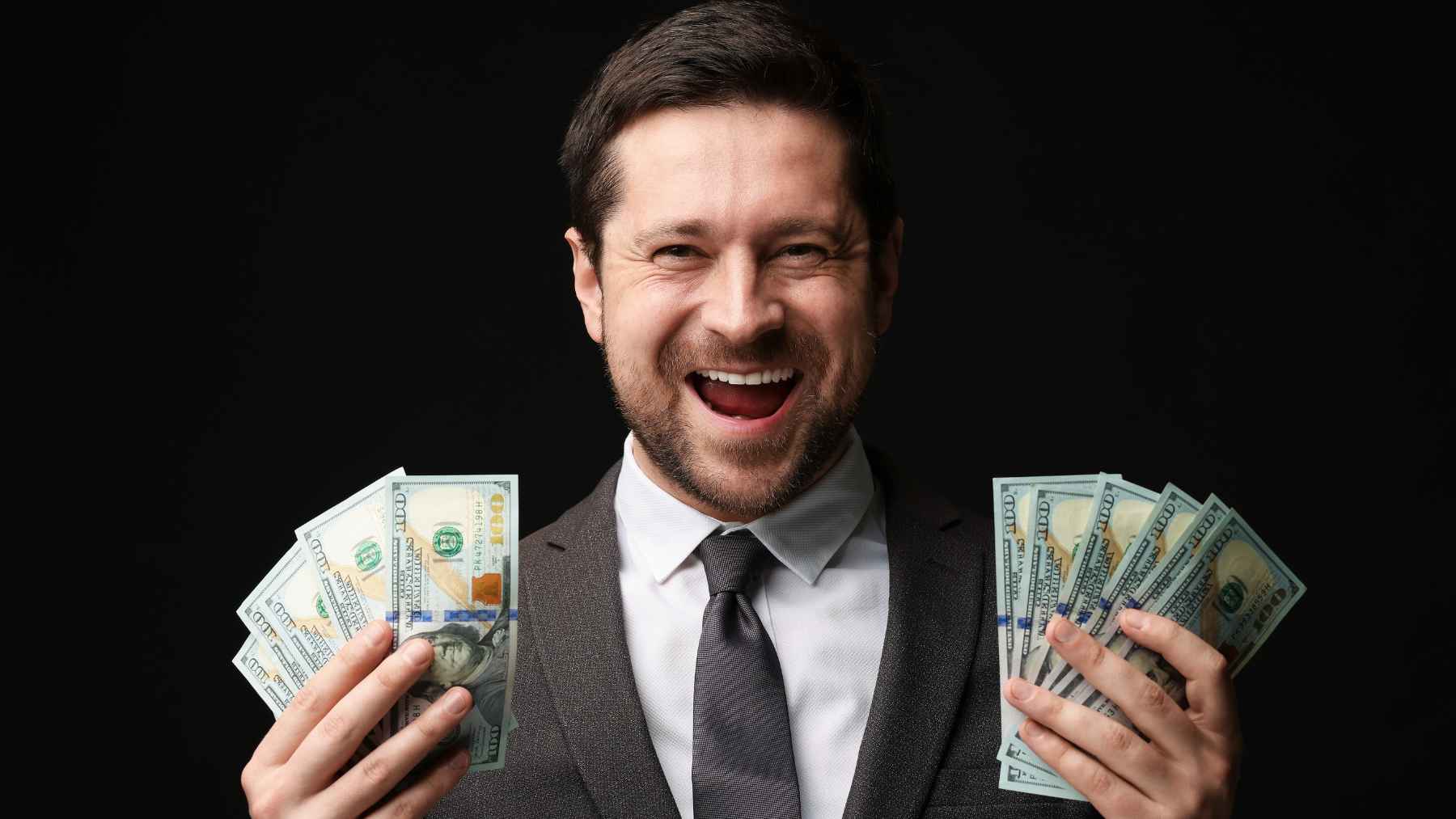 A person feeling relieved while reviewing their finances at a table, representing the peace of mind that comes with economic stability.