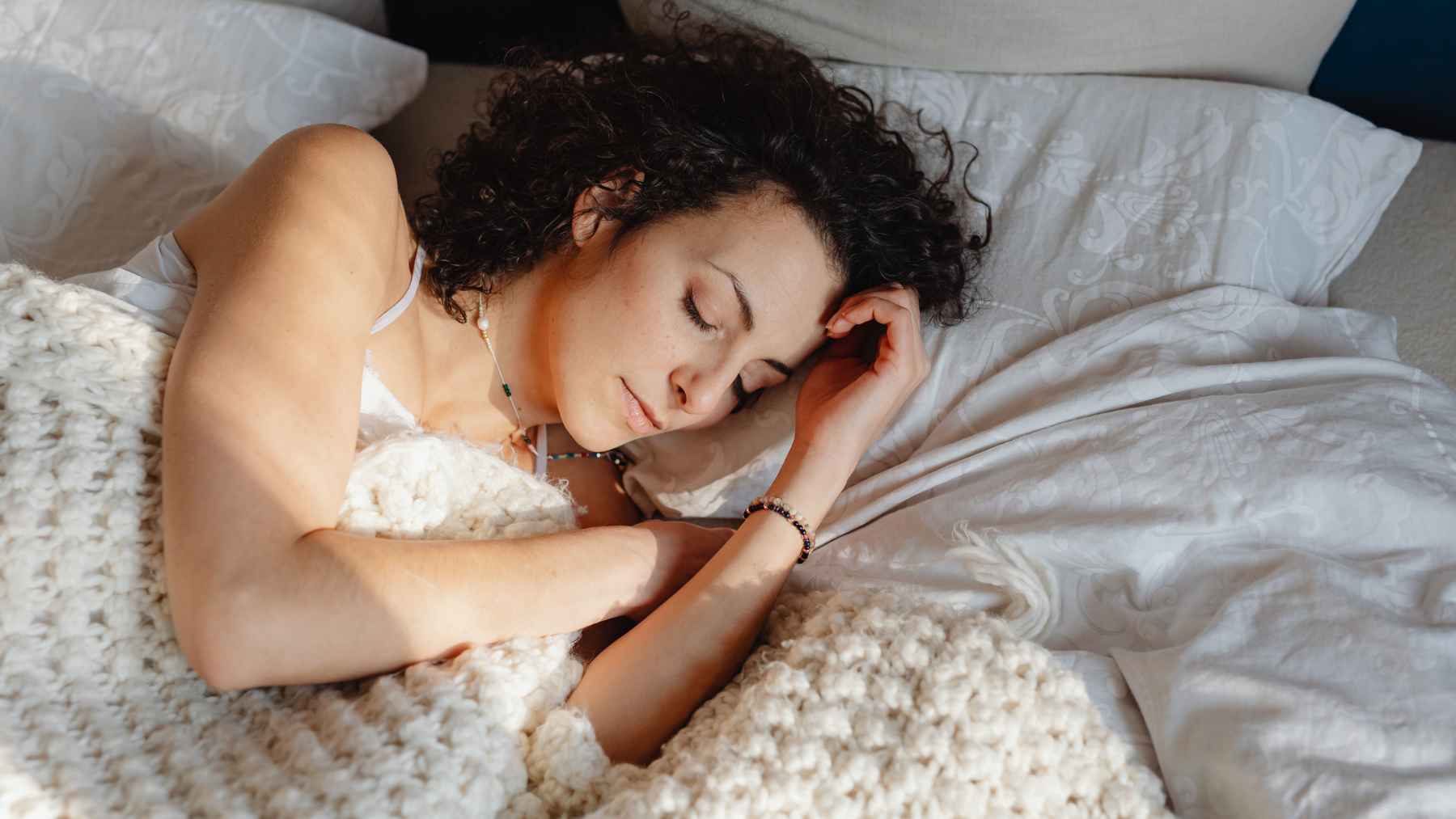 Magnesium supplement capsules displayed beside a glass of water as part of a bedtime routine aimed at improving sleep quality.
