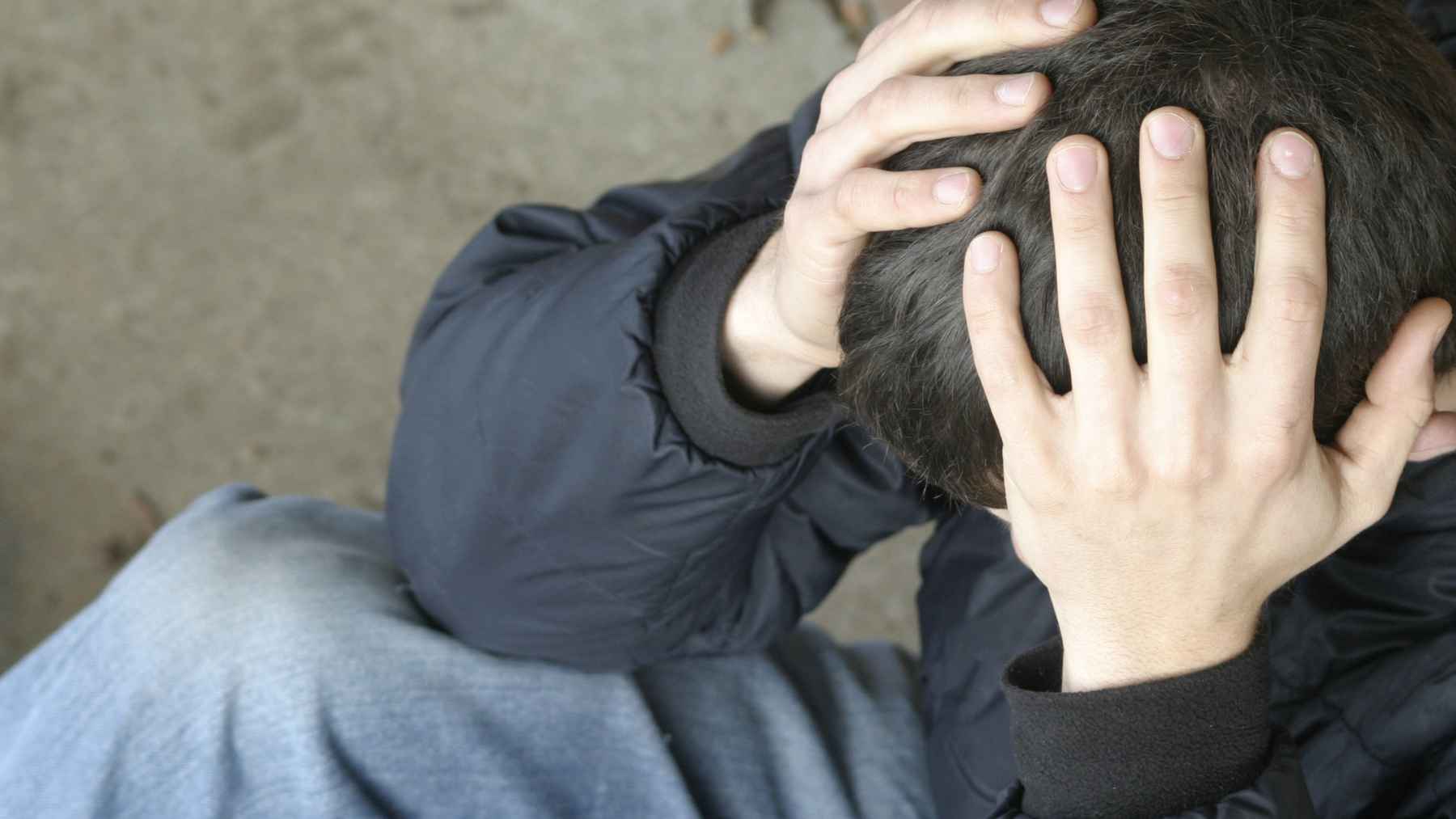 People walking in a Malaysian city as growing concern mounts over financial stress, mental health, and family well-being