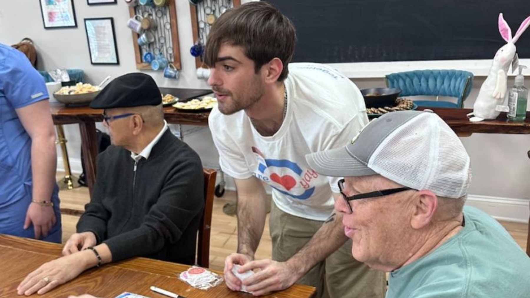 Nursing student Jake Benoit and his 96-year-old friend John sitting together, highlighting the importance of intergenerational connections in eldercare.