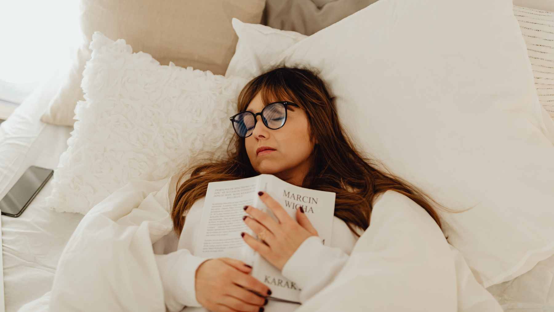 A person taking a brief, timed afternoon power nap in a quiet, dimly lit room to boost cognitive performance and alertness.