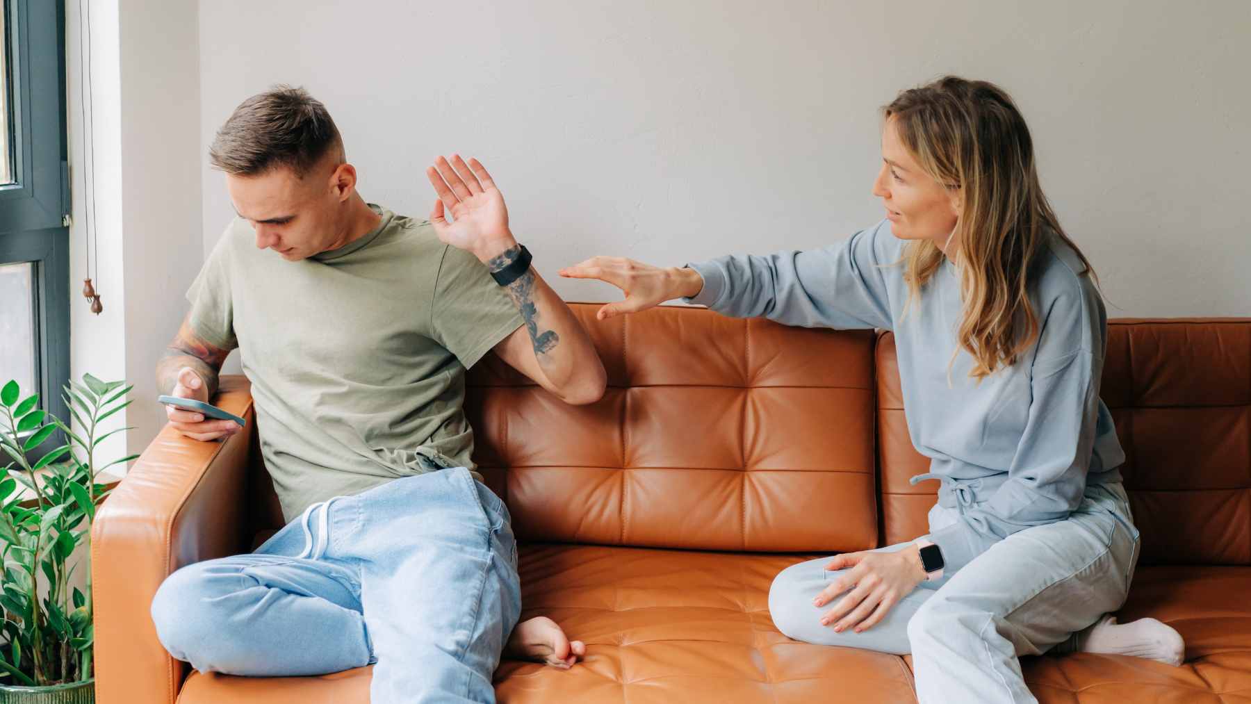 Psychology suggests adults who avoid conflict at all costs are not always more mature, they may have learned early that emotions led to punishment 1 Two people sitting together looking tense and hesitant, representing the internal struggle of conflict avoidance and repressed emotion.