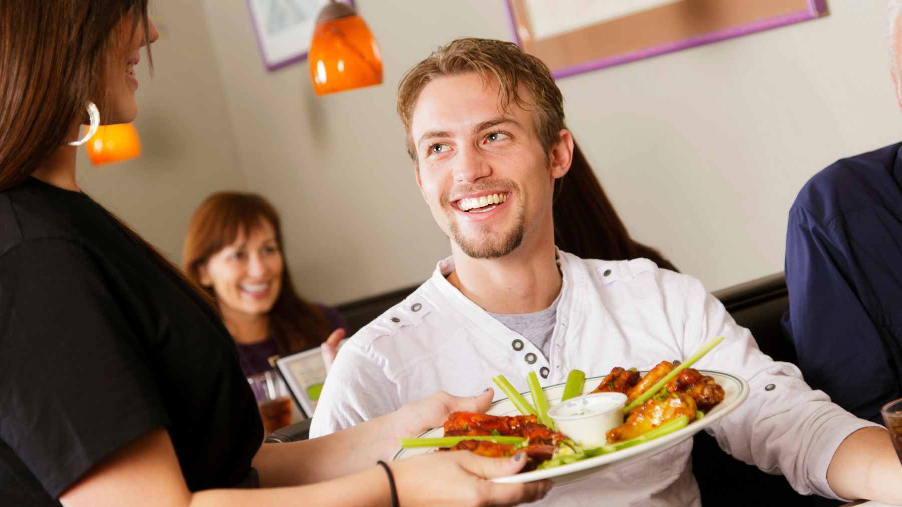 Helping clear the table may look like a kind gesture, but psychologists think it reveals something much deeper 1 A customer stacking empty plates and glasses at a restaurant table to assist the server with cleanup.