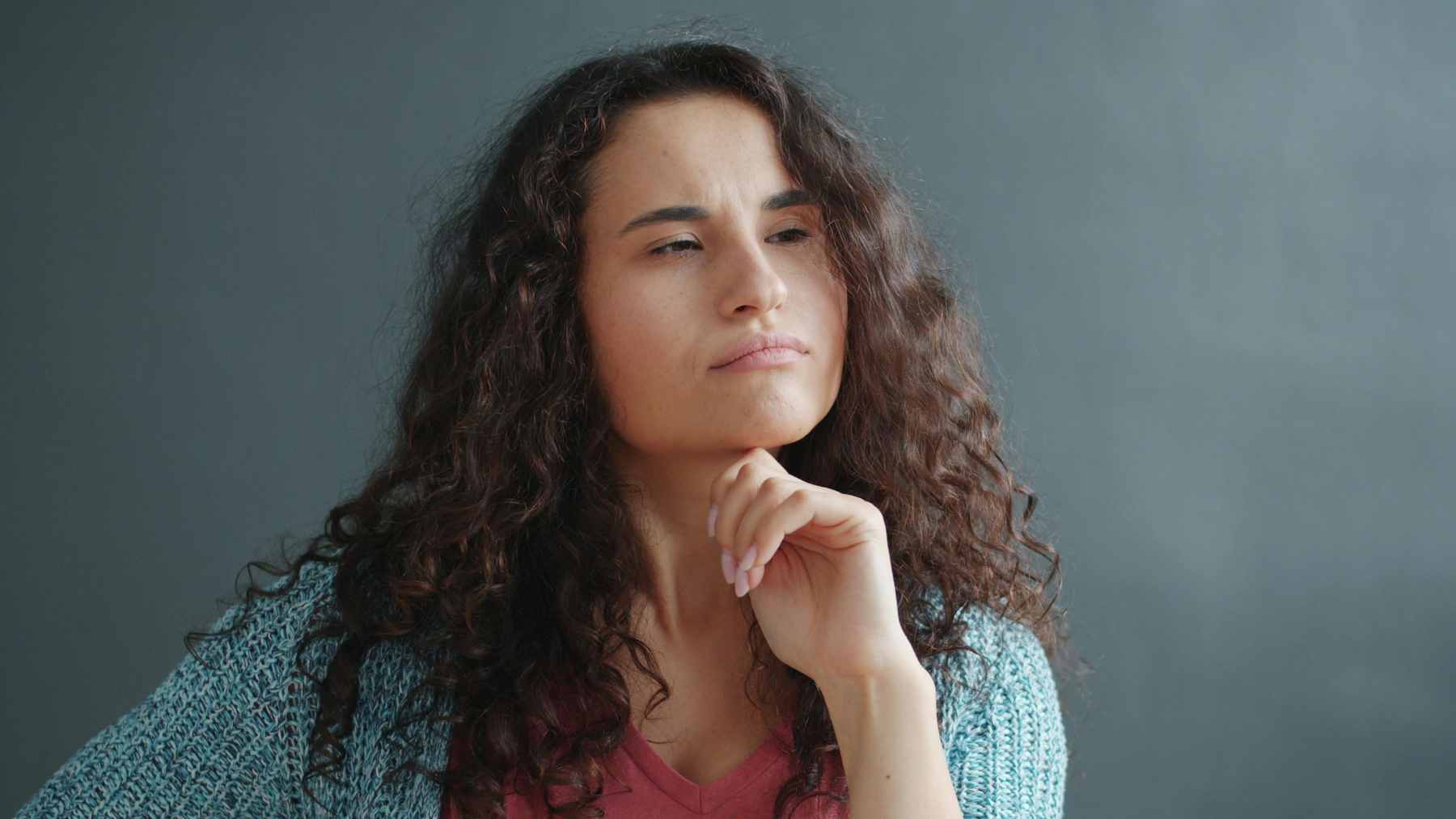 A person pausing in a busy environment to check their physical state, representing the connection between gut instincts and subconscious awareness.