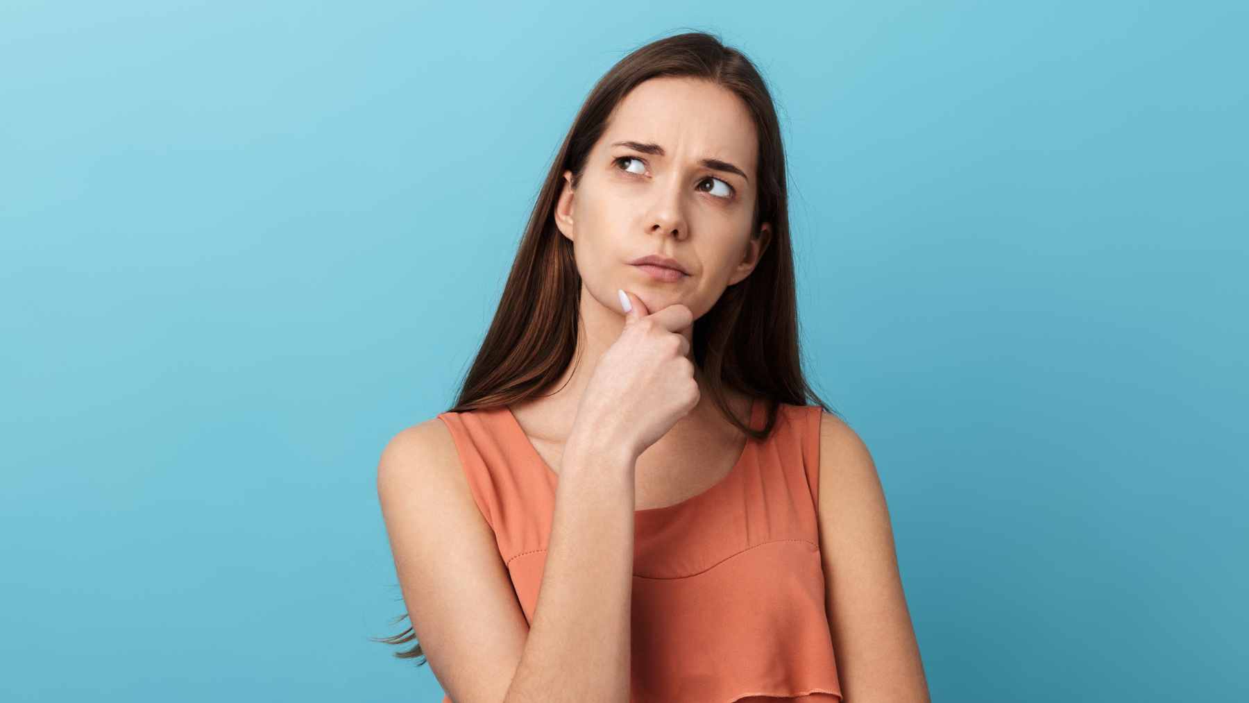 A person pausing in a busy environment to check their physical state, representing the connection between gut instincts and subconscious awareness.