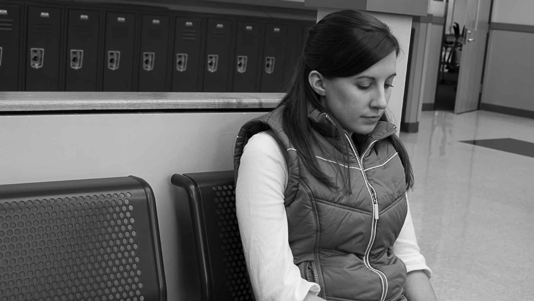 Person sitting alone in a quiet setting, illustrating solitude, introversion, and psychological well-being