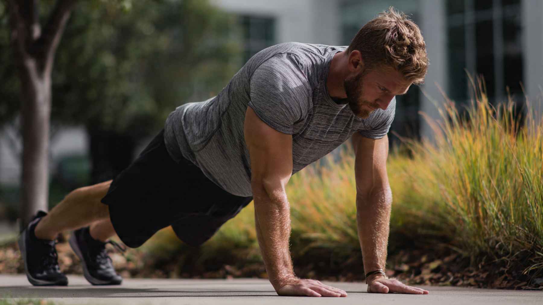 Person performing a controlled push-up with proper form, demonstrating the slow descent and powerful upward phase used for strength training.