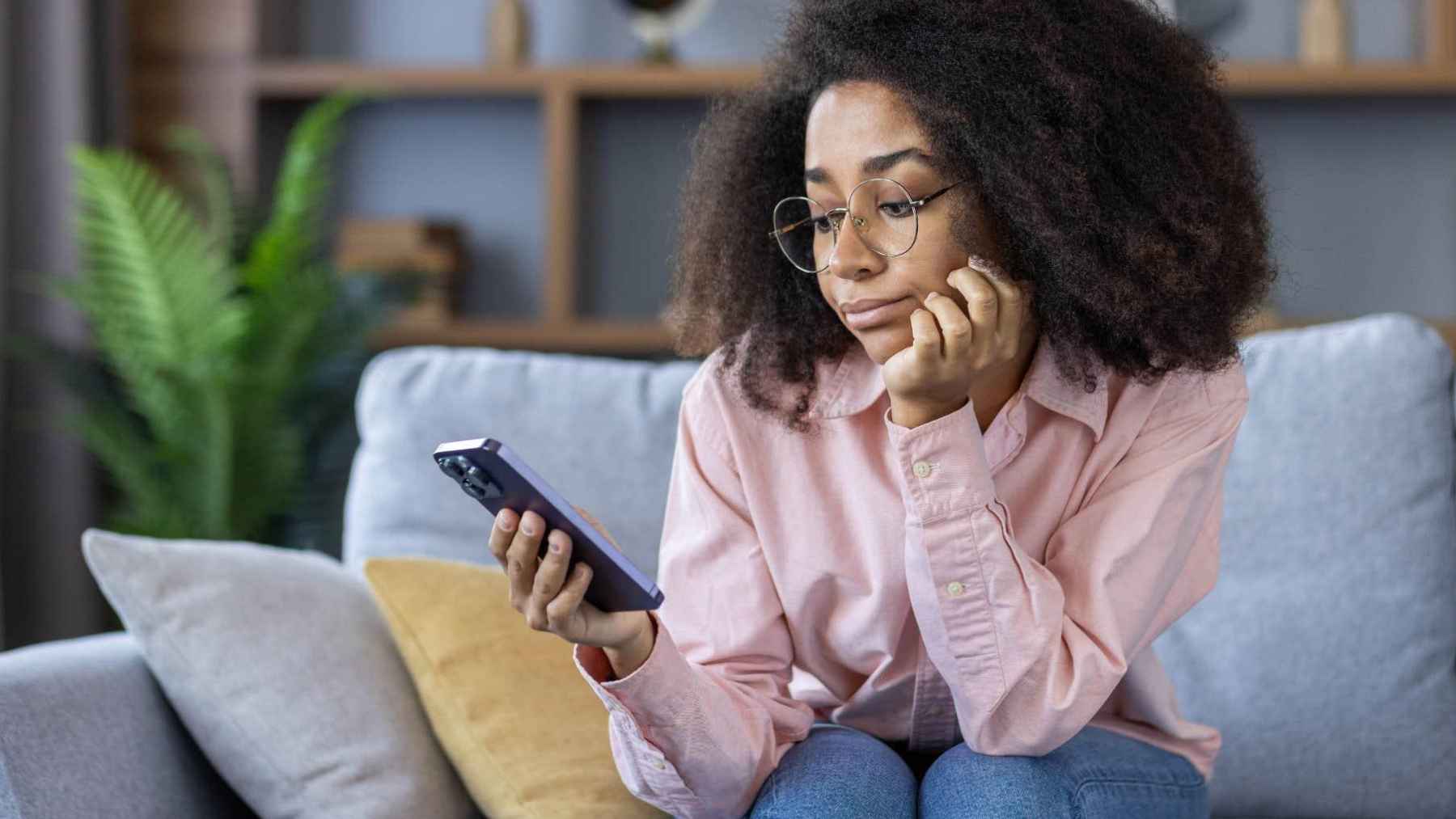 Person sitting alone while using a smartphone, illustrating the connection between social media use, loneliness, and digital burnout.