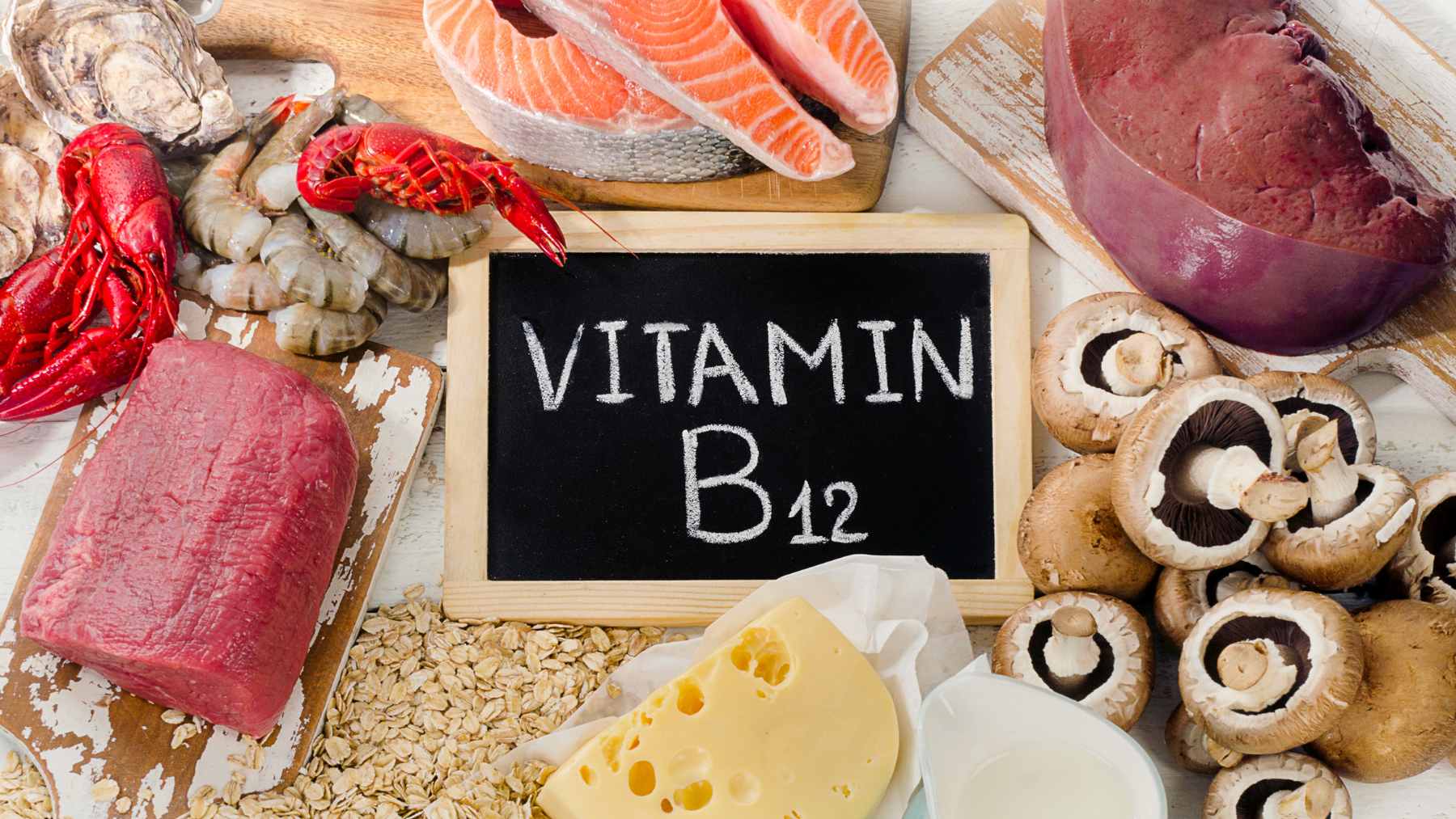 A colorful assortment of B12-rich foods, including salmon, eggs, yogurt, and spinach, presented on a wooden table to highlight dietary sources of the nutrient.