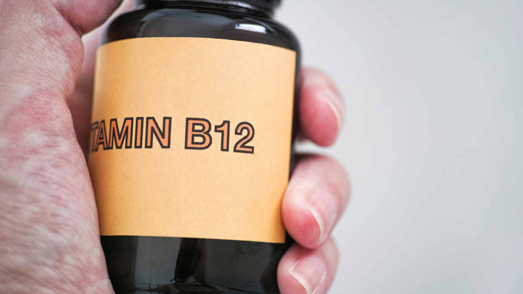 A medical illustration highlighting the role of vitamin B12 in supporting mitochondrial function within skeletal muscle cells to prevent aging-related decline.