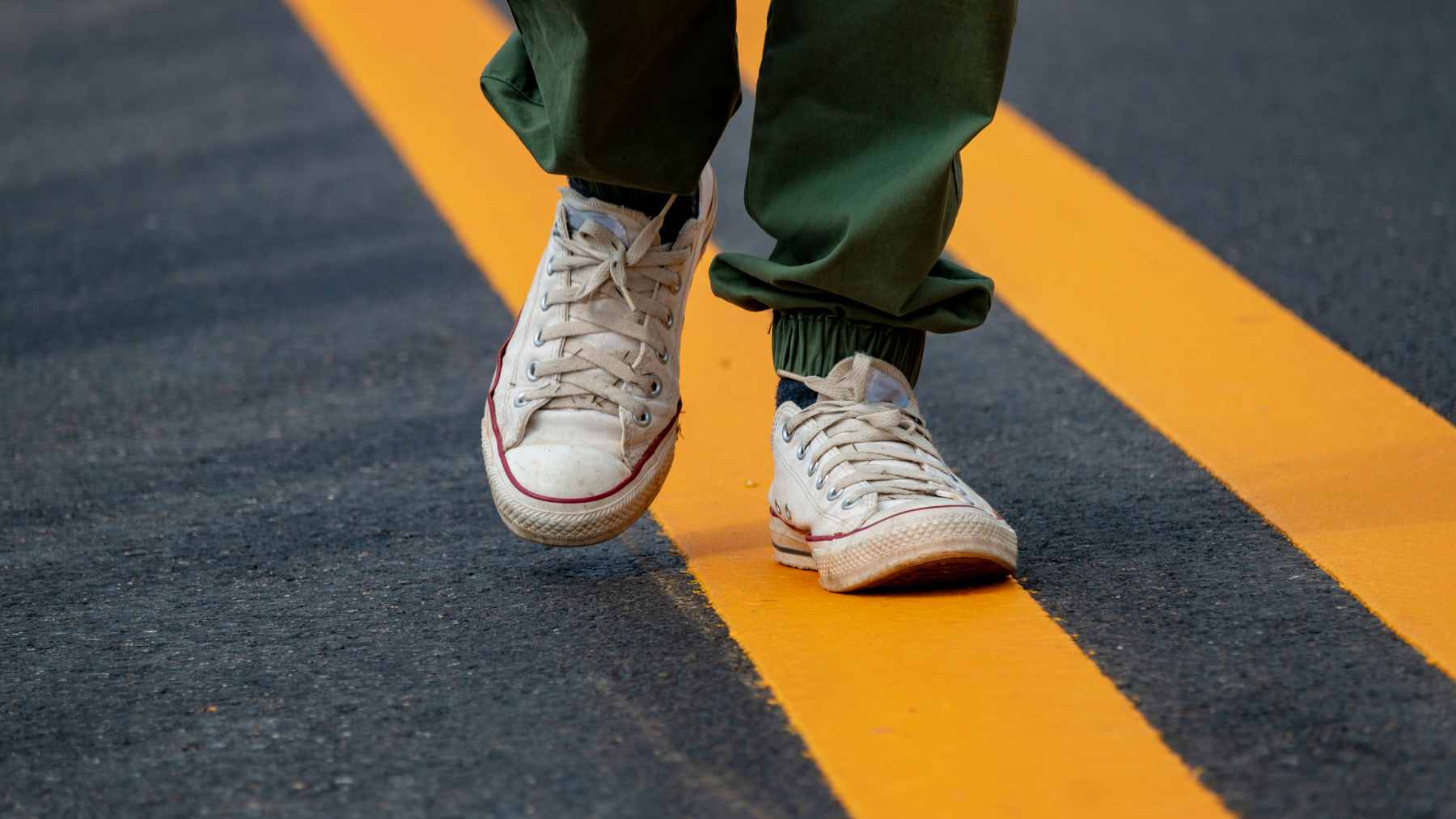 A man taking a brisk, refreshing walk outdoors to improve mental focus and boost physical energy.