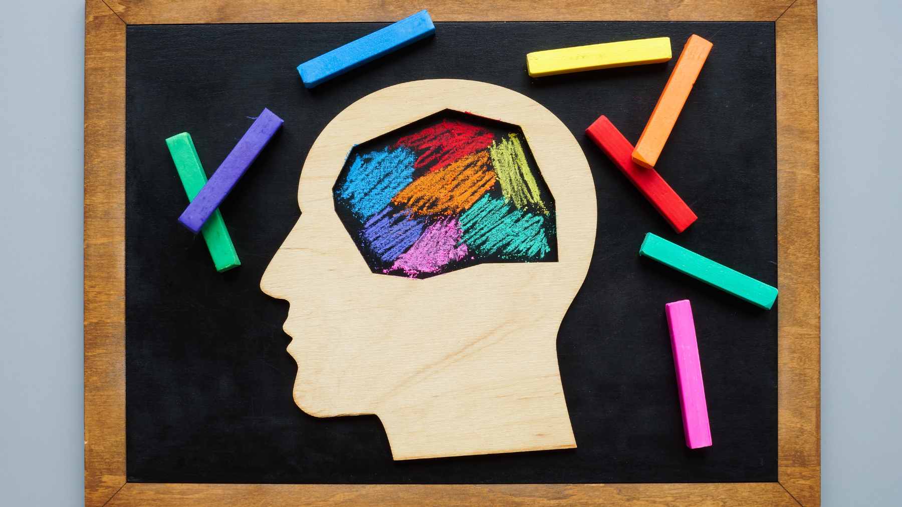A close-up of a young child playing with a brightly colored, textured toy, illustrating sensory engagement.