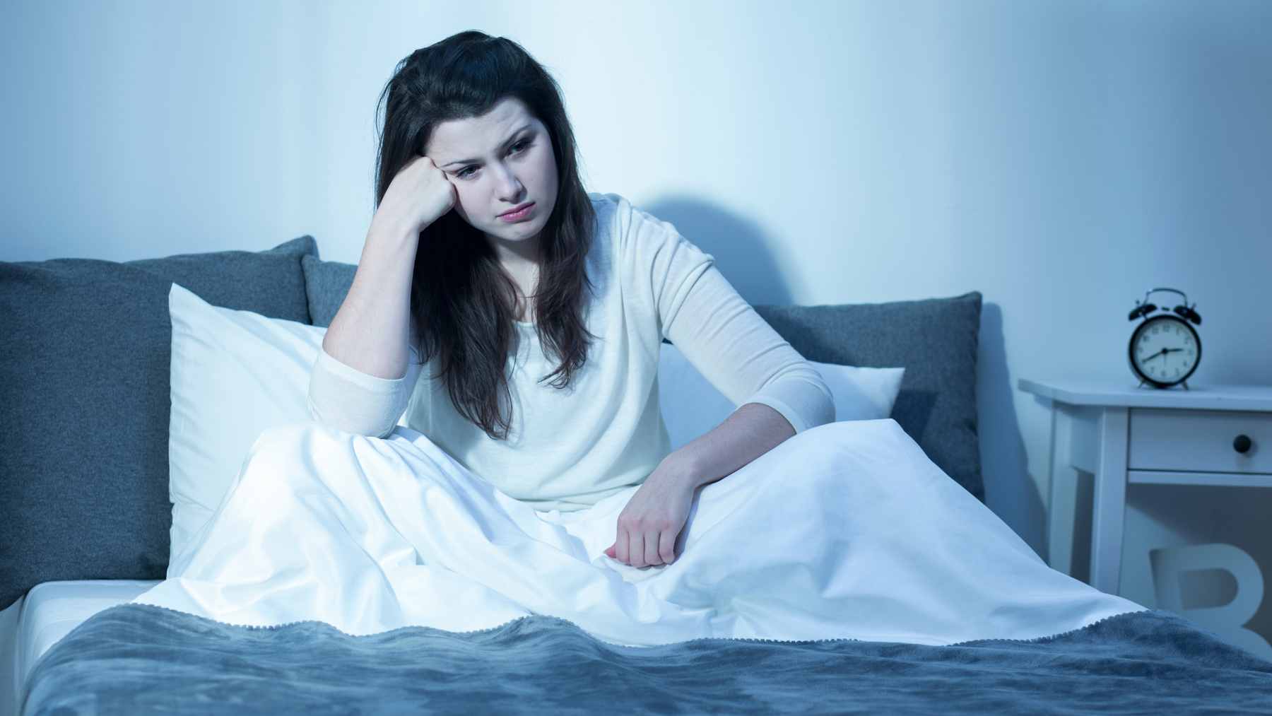 Science says if you survived cancer, this one gentle practice could finally fix your sleep and quiet your anxiety 1 A woman practicing gentle, restorative yoga in a peaceful, sunlit room, illustrating the mind-body practice used in the YOCAS program.