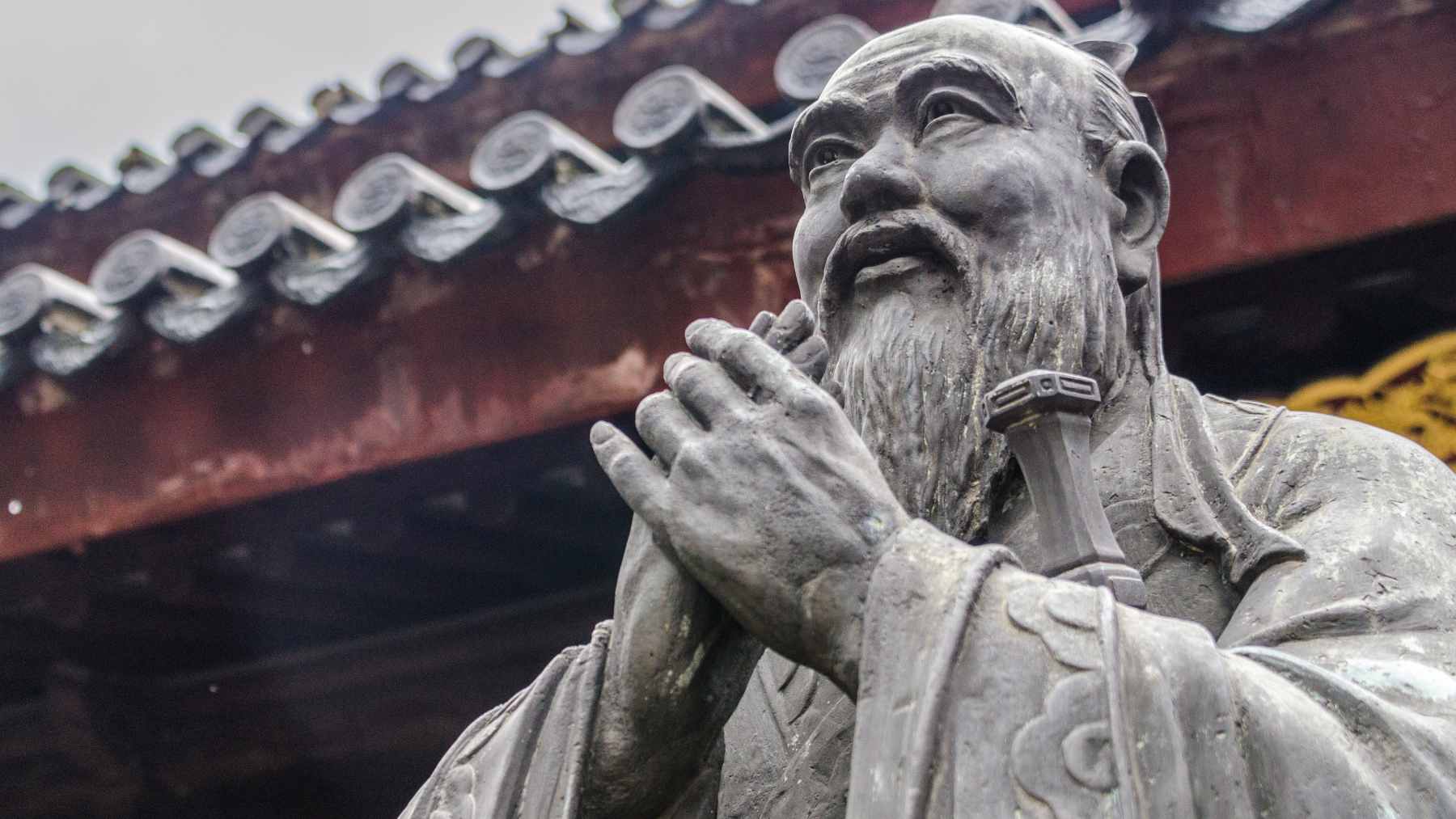 A classic artistic portrait of the philosopher Confucius, representing timeless wisdom regarding mortality and purpose.