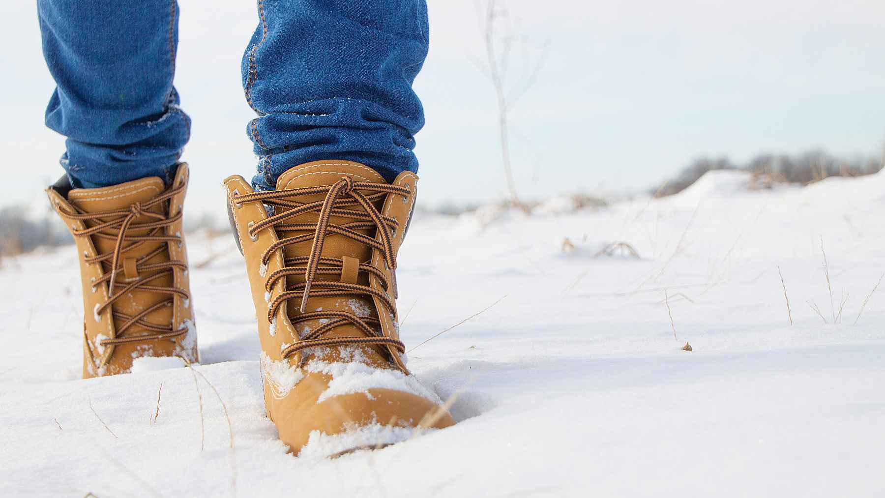 Person with diabetes inspecting their feet while wearing warm winter socks and protective footwear to help prevent foot injuries during cold weather.