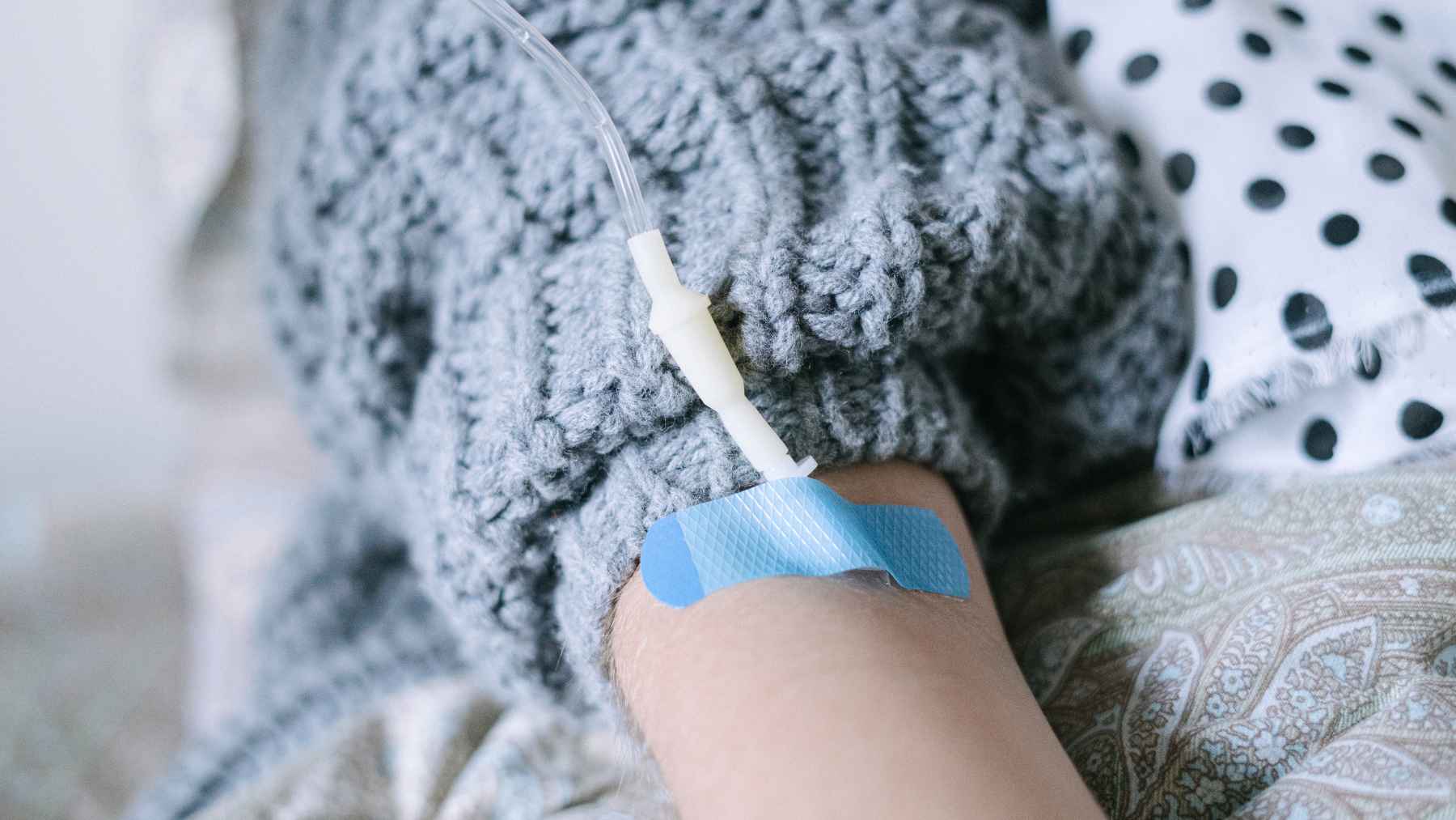 Scientists say adults under 50 are aging faster than past generations, which could help explain why cancer cases keep climbing among the young 1 A patient receives intravenous medical treatment during cancer care, illustrating research into early-onset cancer and accelerated biological aging.
