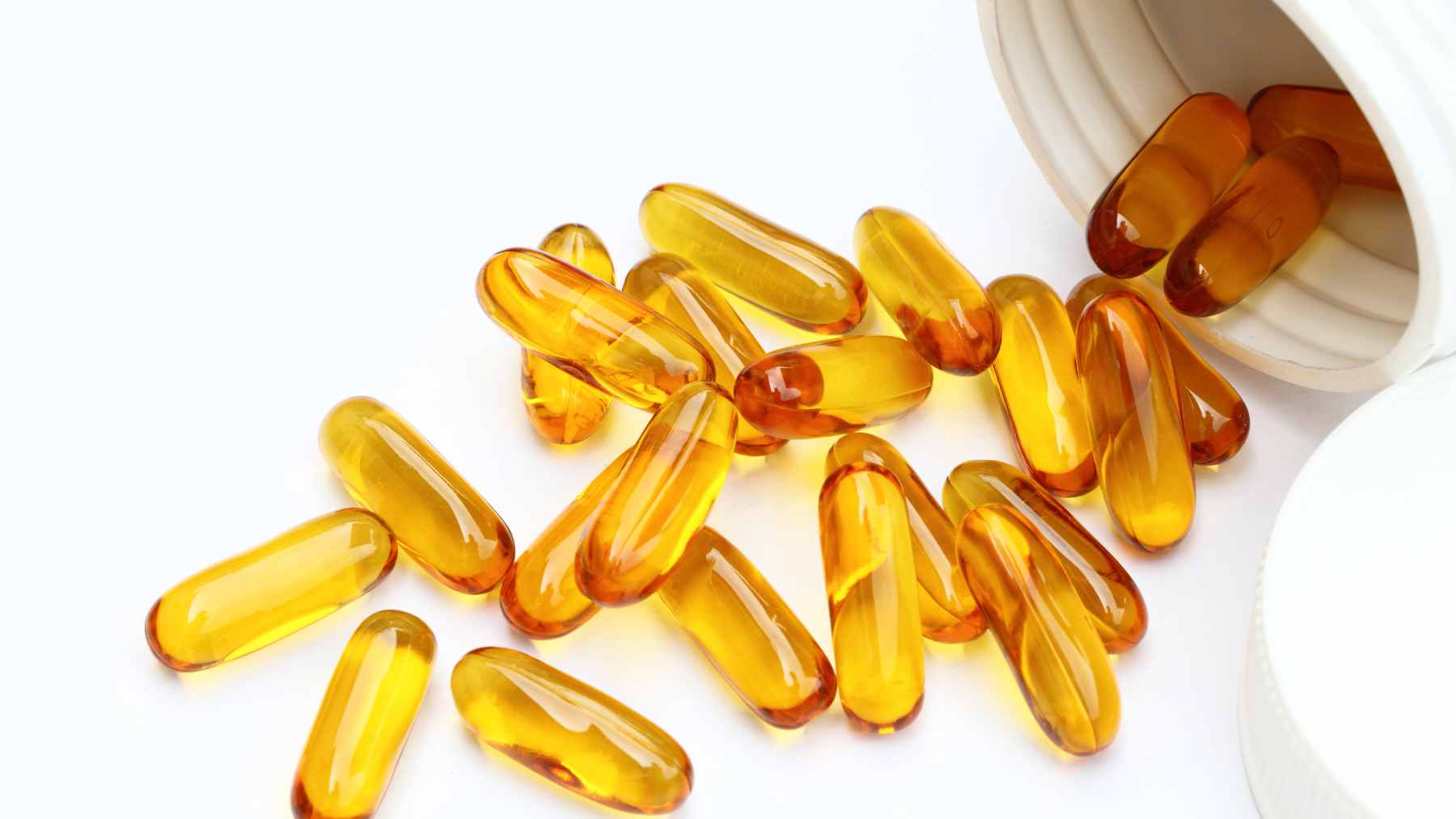Close-up of a fish oil supplement capsule next to a plate of fresh salmon, symbolizing the difference between isolated nutrients and whole foods for brain health.