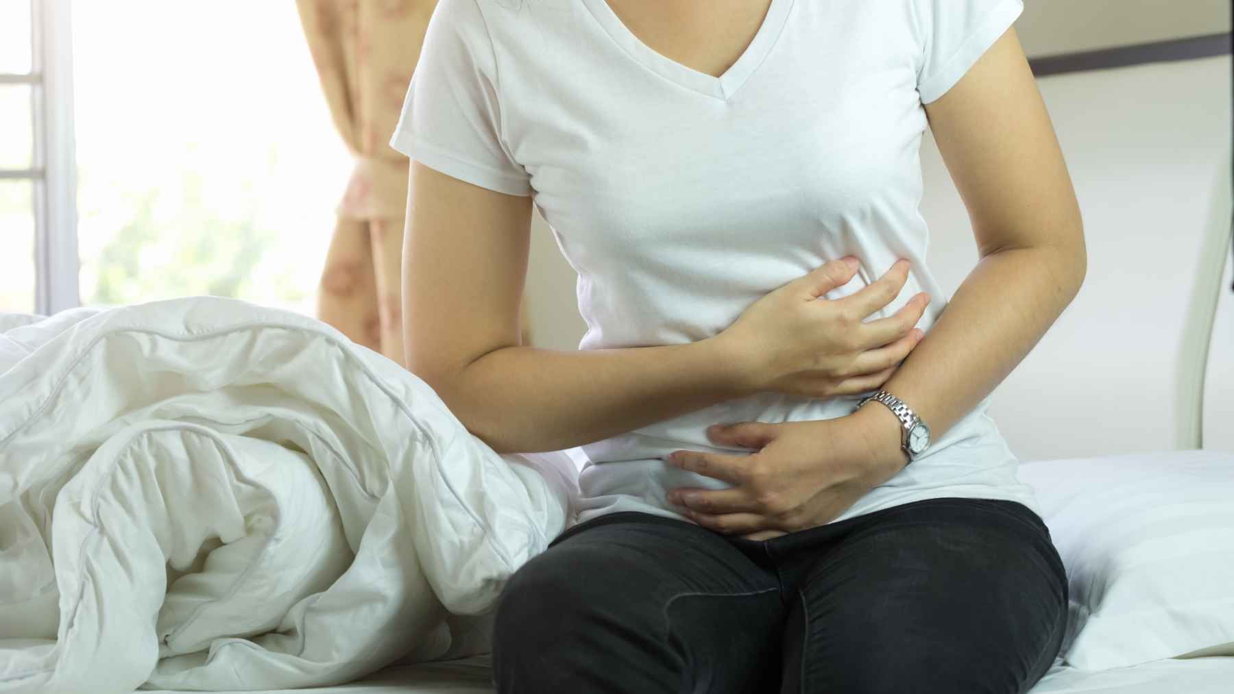 Person following healthy daily habits to promote natural bowel movements and relieve constipation without relying on laxatives.
