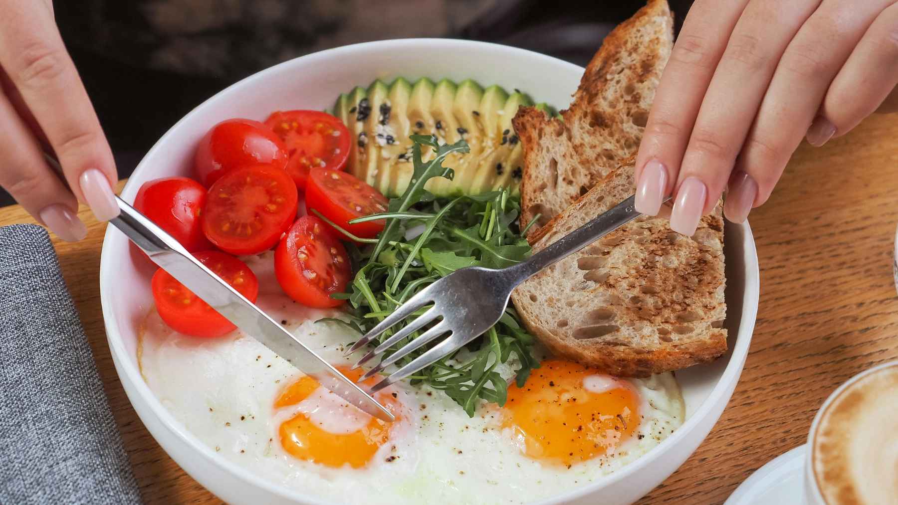 A variety of high-fiber foods including whole grains, beans, fruits, vegetables, nuts, and seeds arranged for a healthy meal.