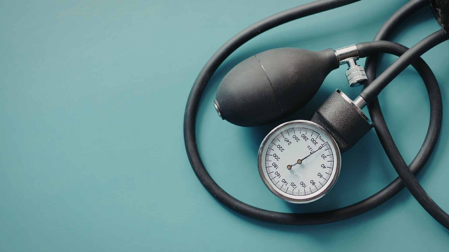 This is the ideal blood pressure for your age, and the single number that helps prevent heart attacks and strokes 1 A healthcare professional checking a patient's blood pressure using an automated digital upper arm monitor in a clinical setting.