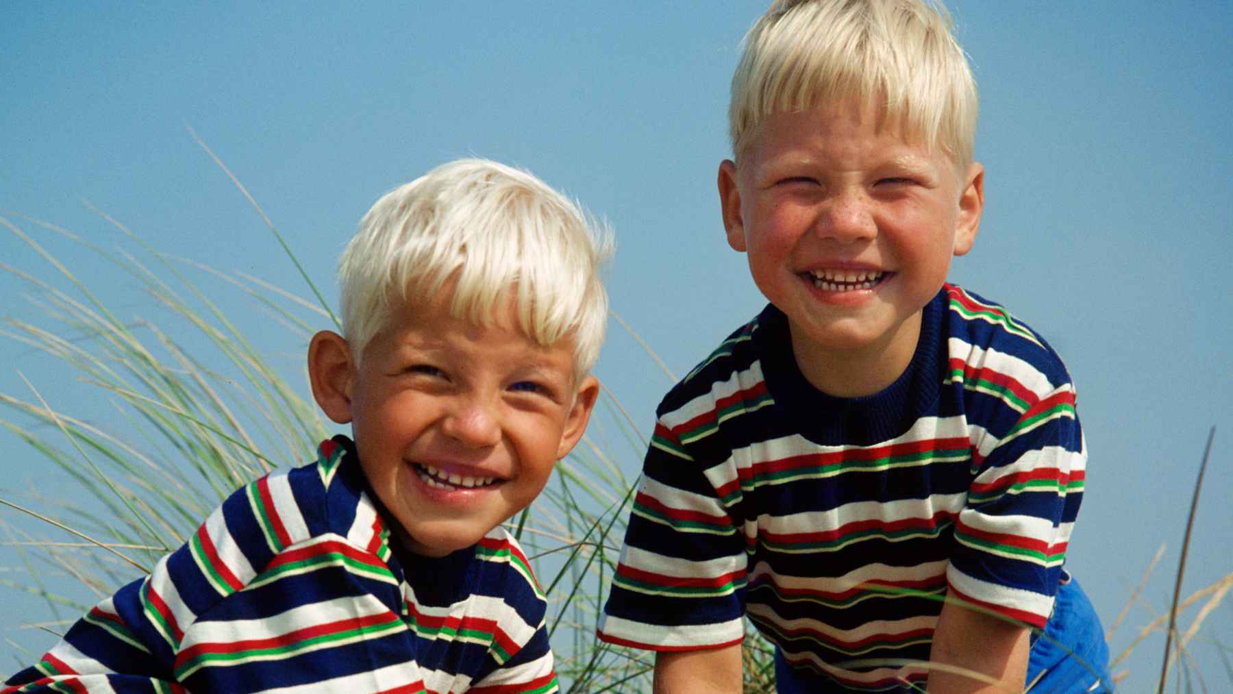 Identical twins participating in a health assessment, illustrating research linking the immune receptor CD300e to obesity and fat metabolism.